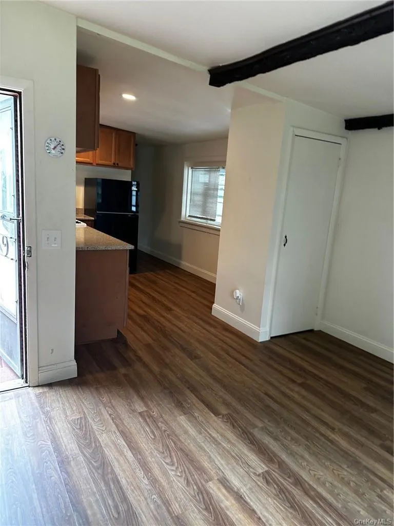 Kitchen with dark wood-type flooring and beamed ceiling Kitchen with dark wood-type flooring and beamed ceiling