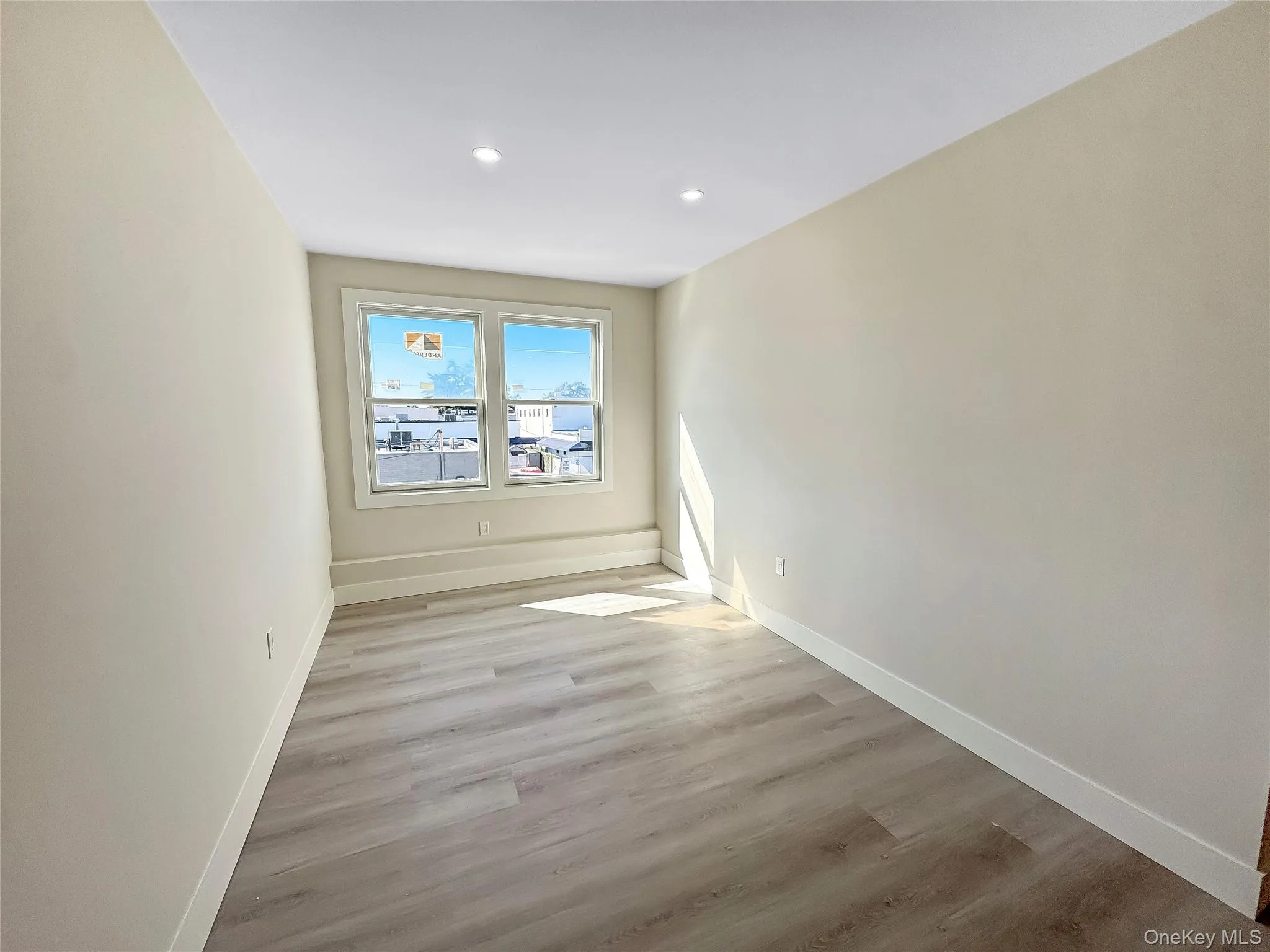 Empty room with light wood-style floors and recessed lighting Empty room with light wood-style floors and recessed lighting