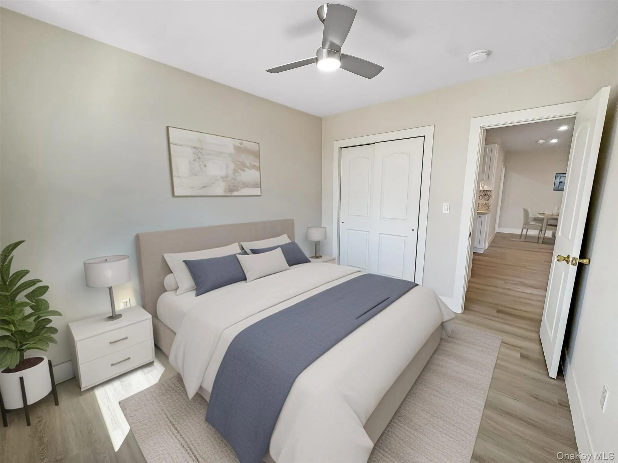 Bedroom with wood finished floors, ceiling fan, and a closet Bedroom with wood finished floors, ceiling fan, and a closet