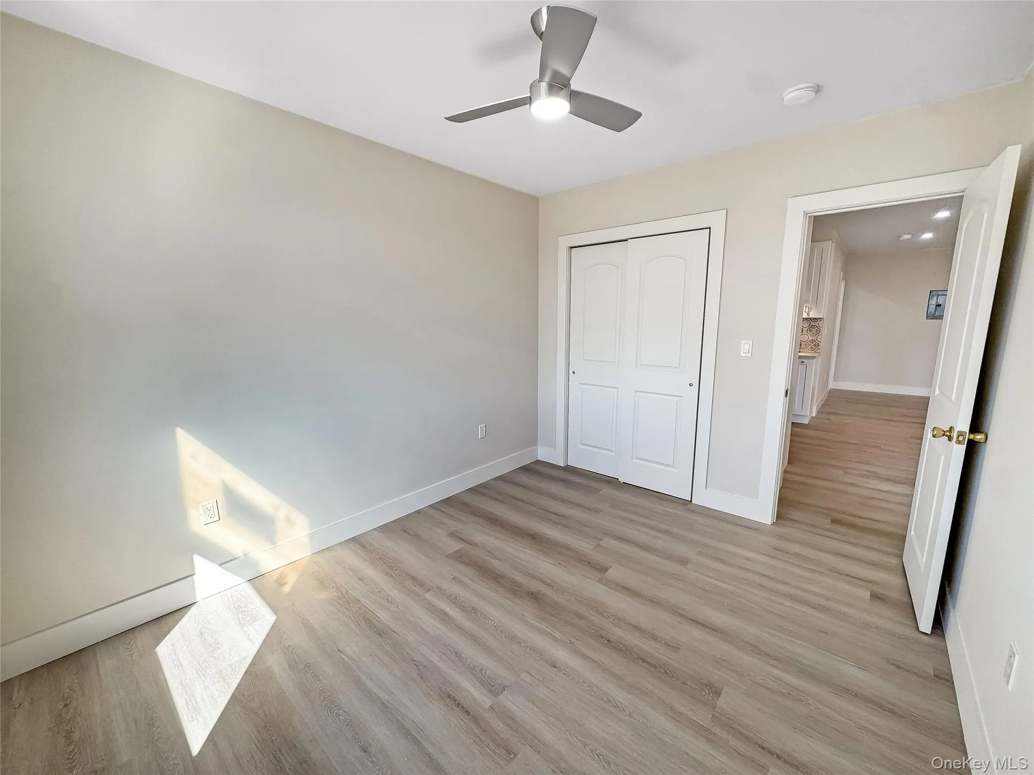Unfurnished bedroom with light wood-type flooring, ceiling fan, and a closet Unfurnished bedroom with light wood-type flooring, ceiling fan, and a closet