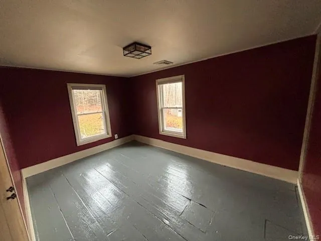 Spare room featuring wood-type flooring and a textured ceiling Spare room featuring wood-type flooring and a textured ceiling