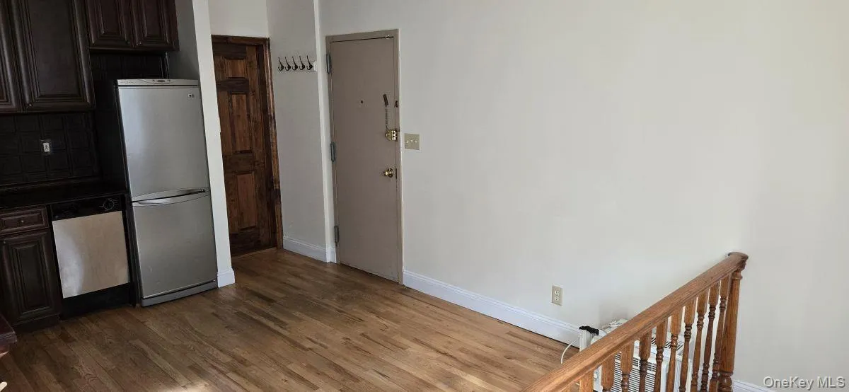 Kitchen with dark brown cabinetry, appliances with stainless steel finishes, dark countertops, and dark wood-style floors Kitchen with dark brown cabinetry, appliances with stainless steel finishes, dark countertops, and dark wood-style floors