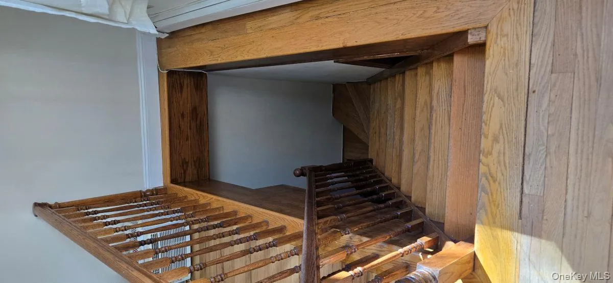 Stairway featuring wood-type flooring Stairway featuring wood-type flooring