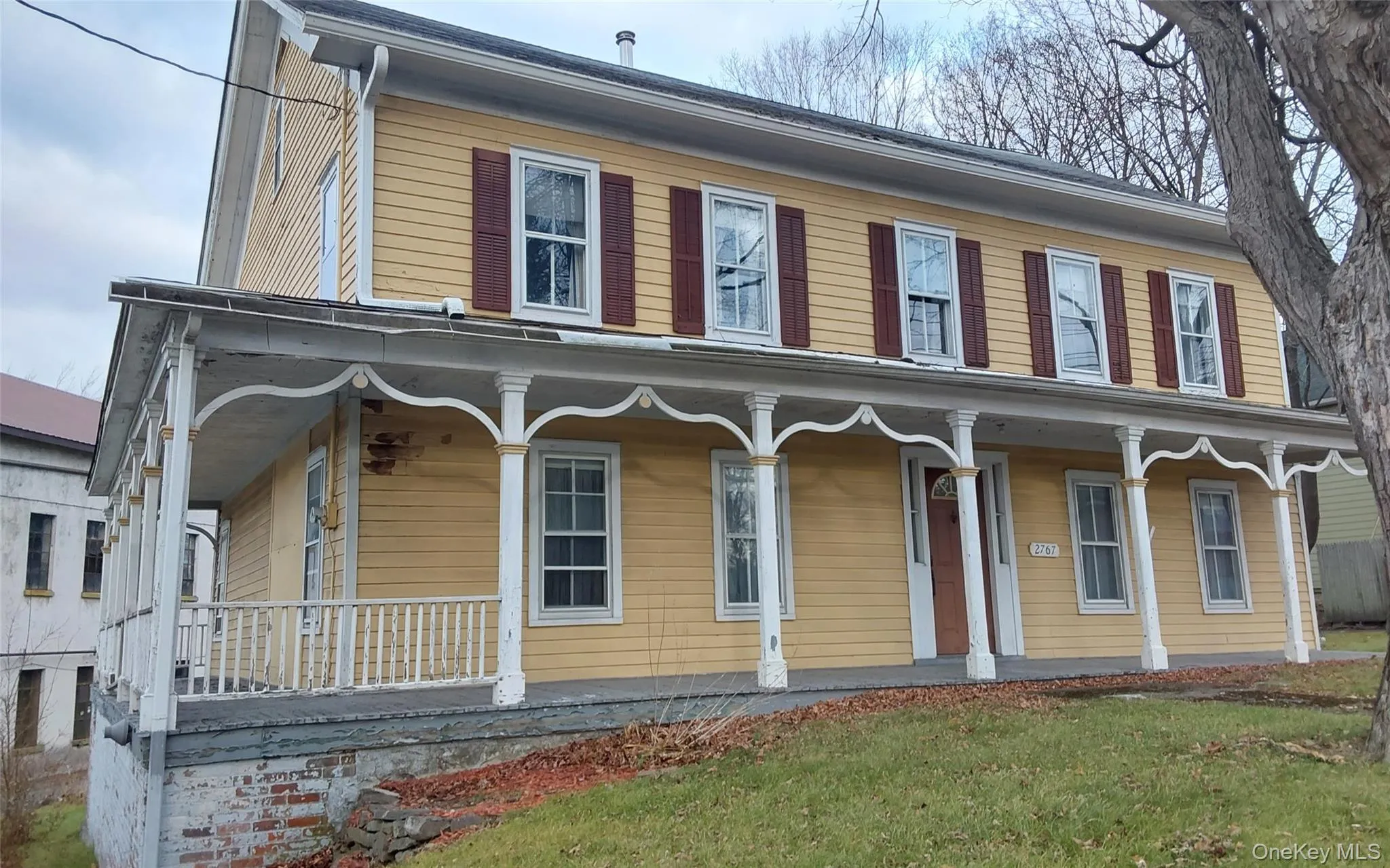 View of front facade with covered porch and a front yard View of front facade with covered porch and a front yard