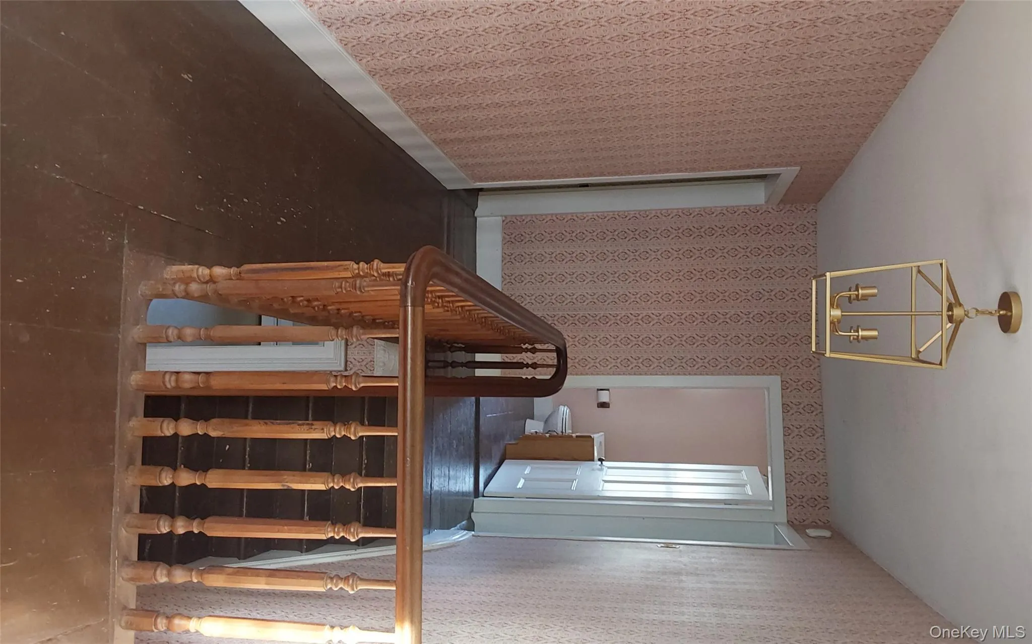 Staircase with wallpapered walls and a chandelier Staircase with wallpapered walls and a chandelier