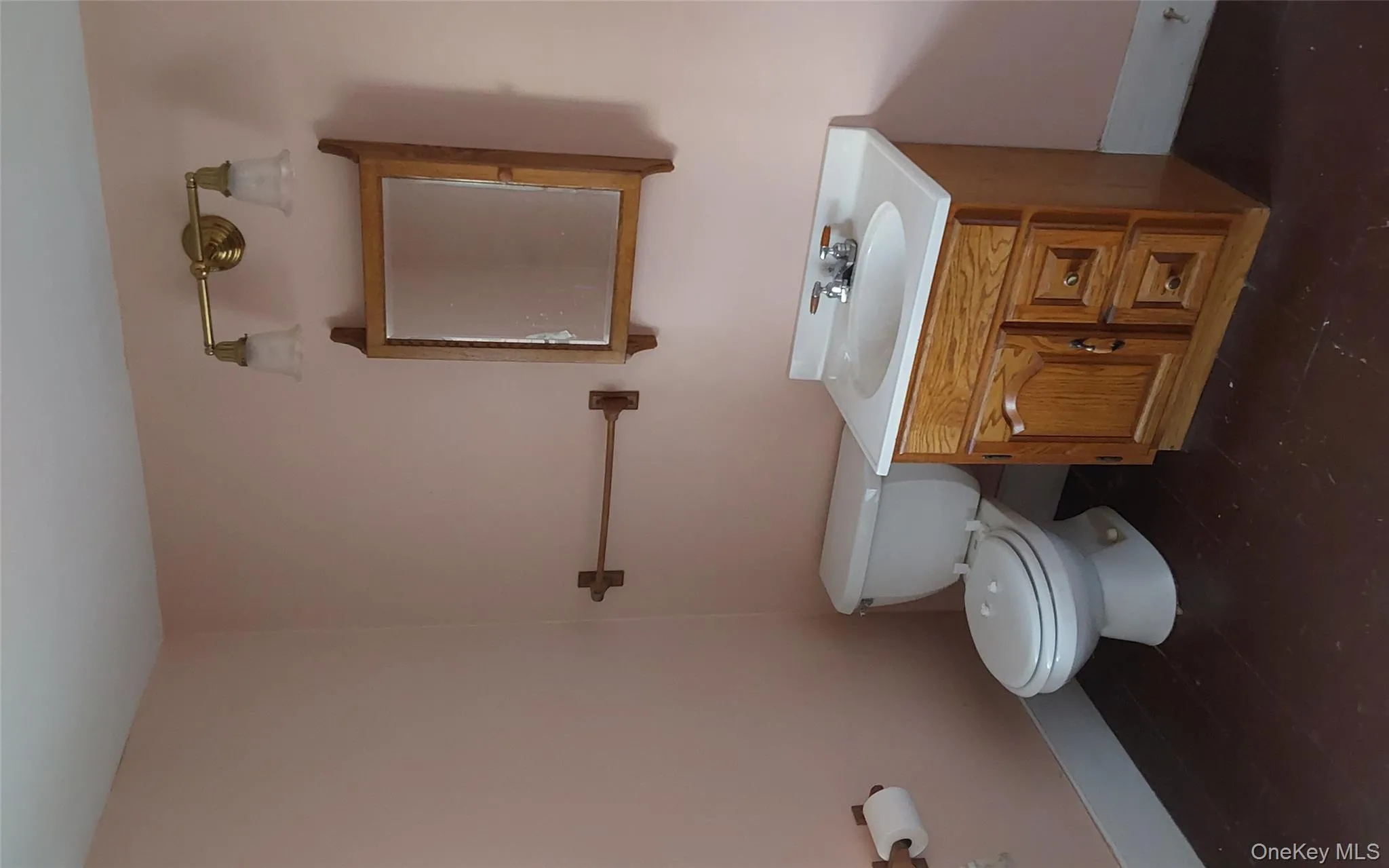 Half bath featuring vanity and toilet Half bath featuring vanity and toilet