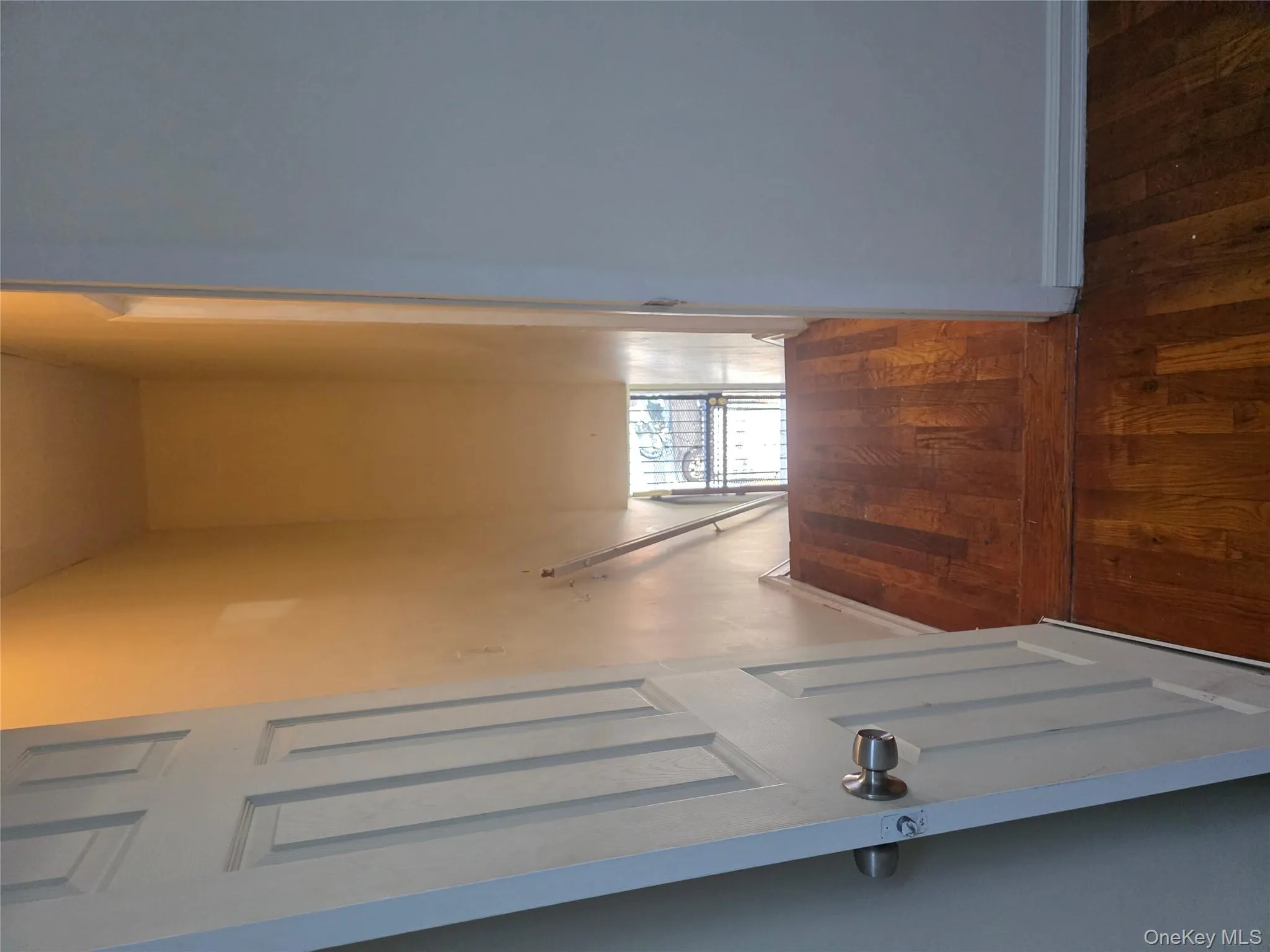 Hallway with baseboards and dark wood-type flooring Hallway with baseboards and dark wood-type flooring