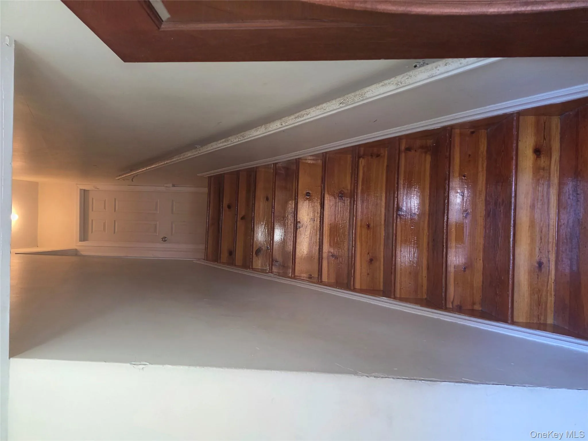 Stairway featuring baseboards and hardwood / wood-style flooring Stairway featuring baseboards and hardwood / wood-style flooring