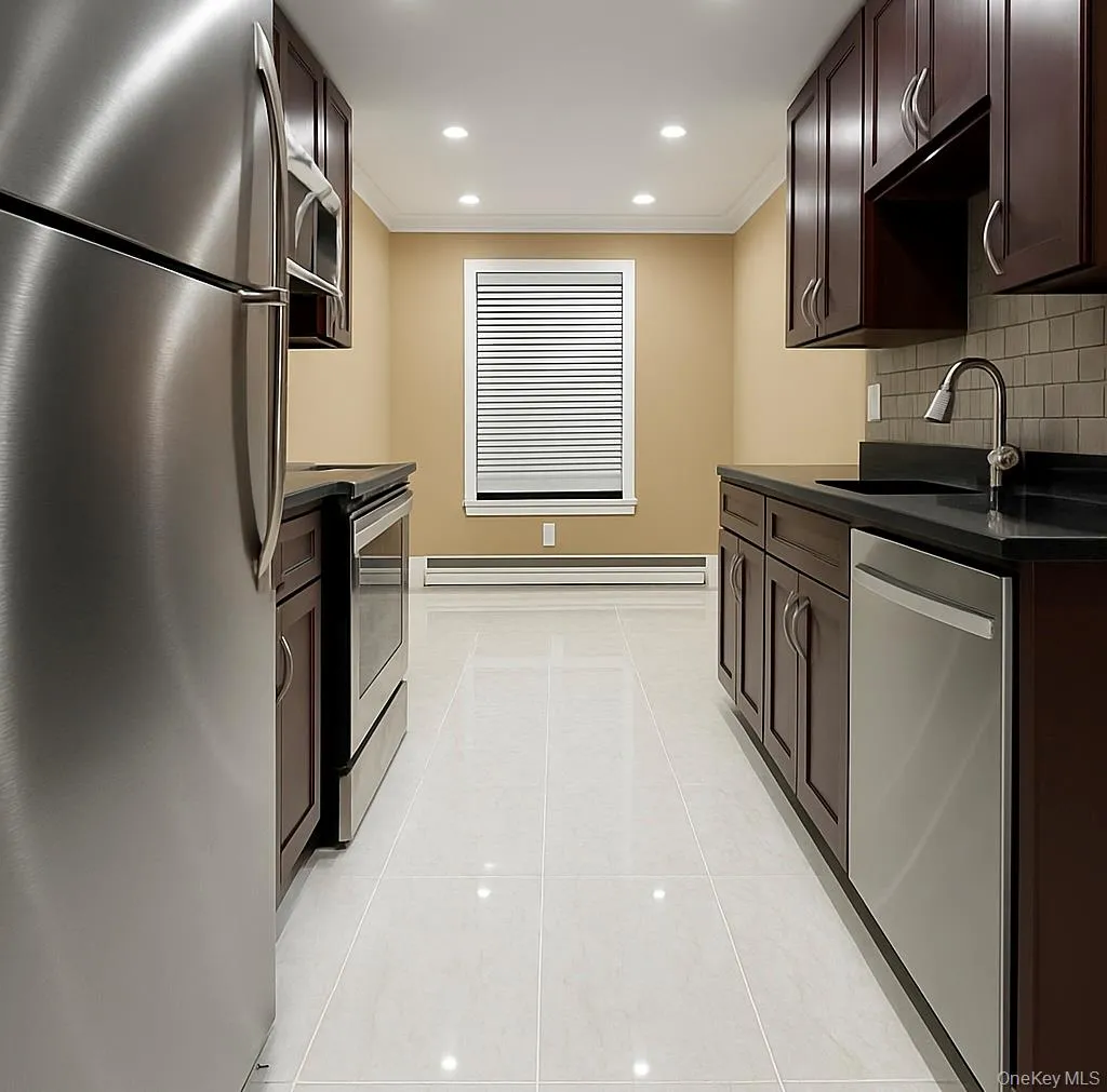 Kitchen with stainless steel appliances, dark brown cabinetry, crown molding, recessed lighting, and light tile patterned flooring Kitchen with stainless steel appliances, dark brown cabinetry, crown molding, recessed lighting, and light tile patterned flooring