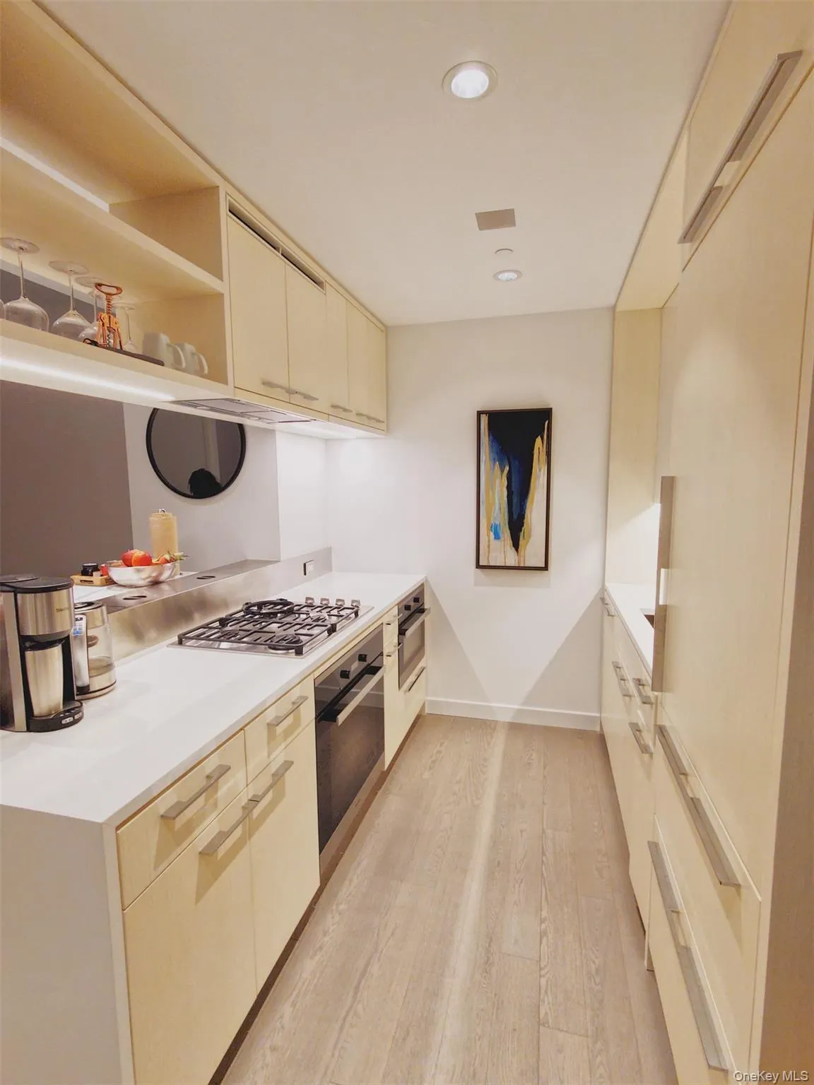 Kitchen featuring open shelves, appliances with stainless steel finishes, light wood-style floors, recessed lighting, and modern cabinets Kitchen featuring open shelves, appliances with stainless steel finishes, light wood-style floors, recessed lighting, and modern cabinets