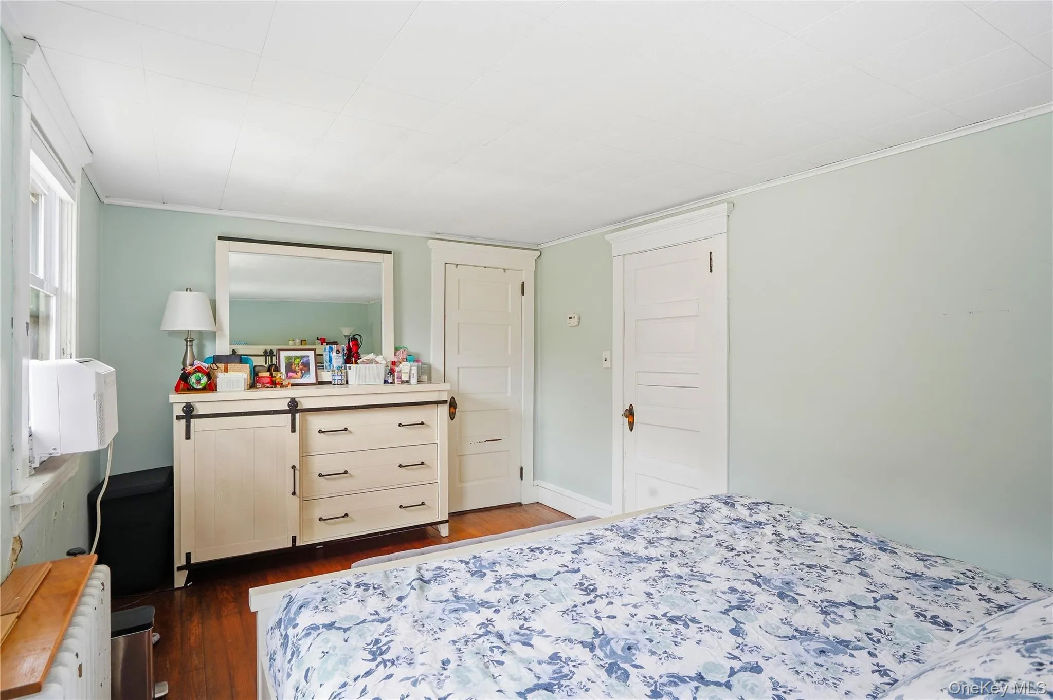 Bedroom featuring dark wood-style floors and crown molding Bedroom featuring dark wood-style floors and crown molding