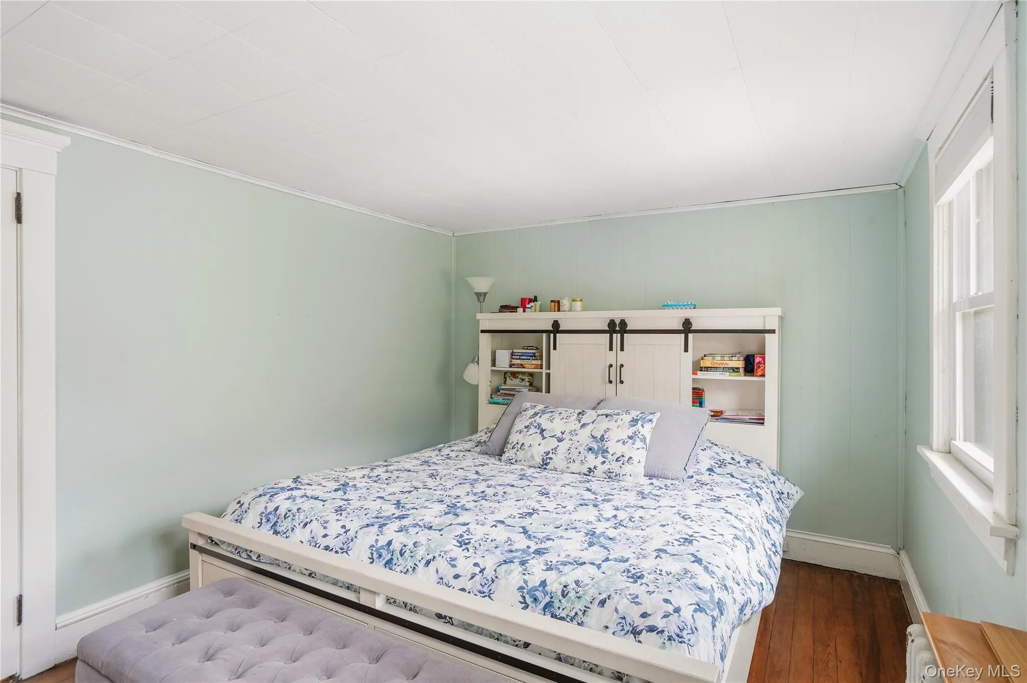 Bedroom featuring baseboards and wood finished floors Bedroom featuring baseboards and wood finished floors
