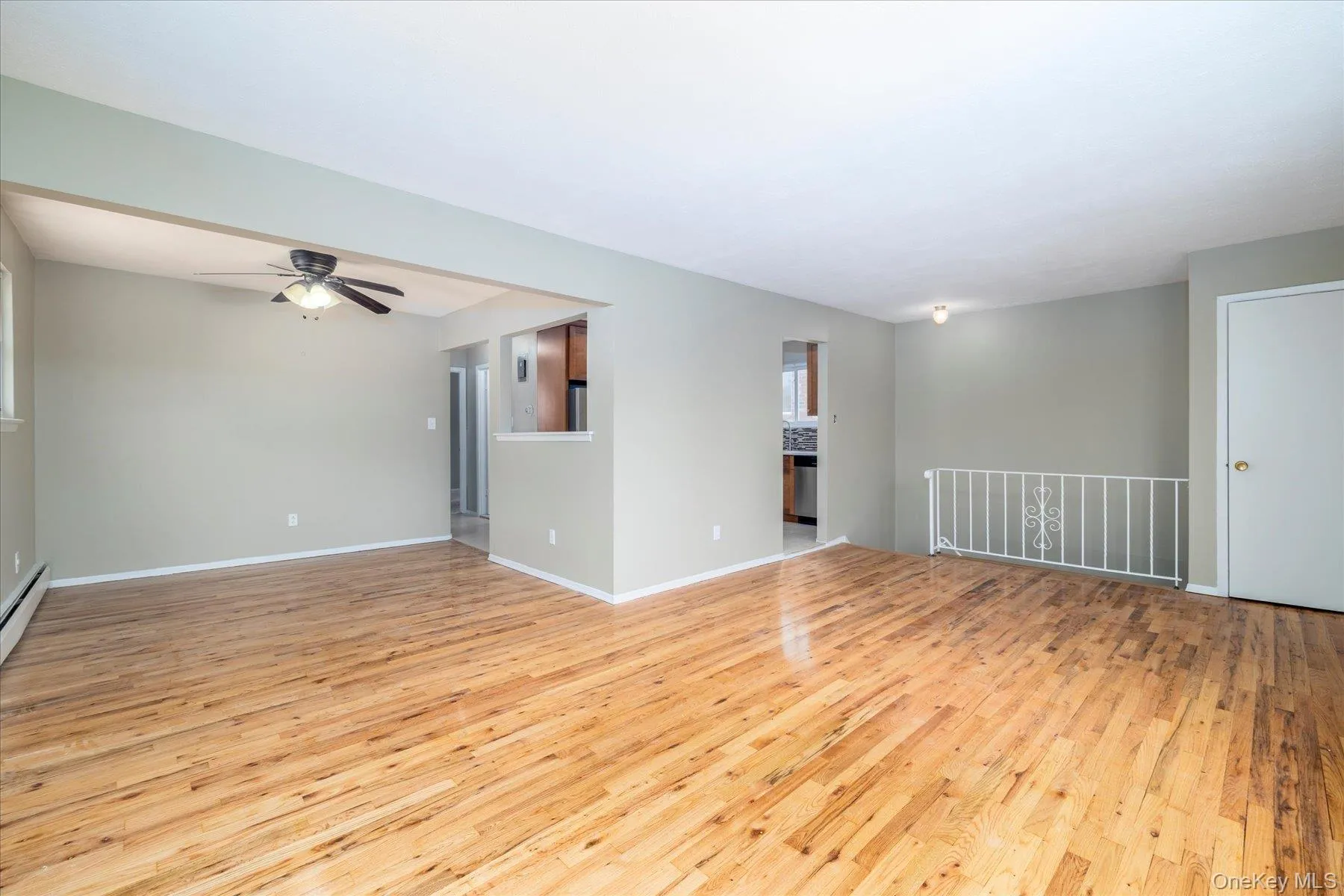 Unfurnished room featuring light wood finished floors and ceiling fan Unfurnished room featuring light wood finished floors and ceiling fan