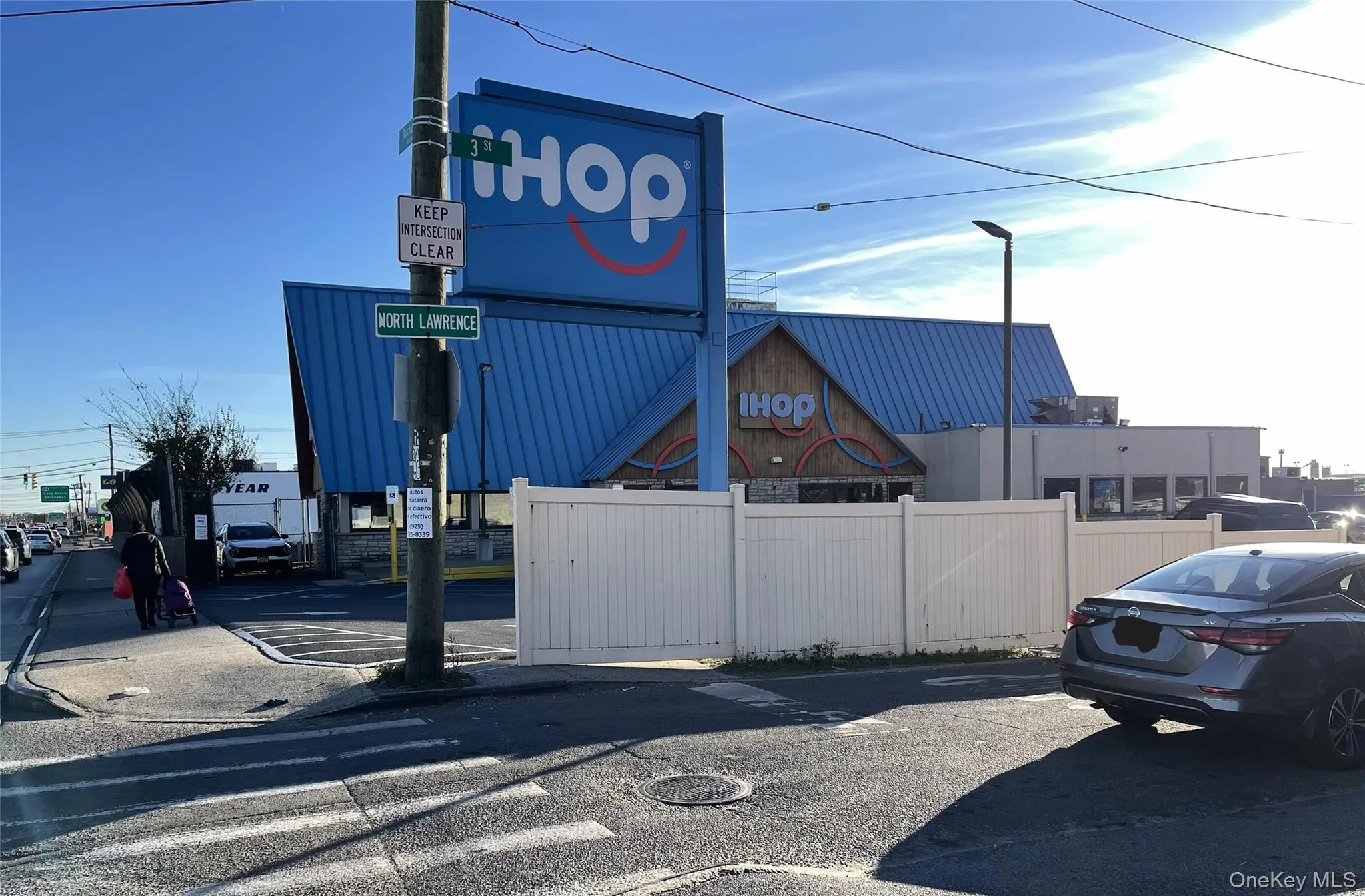 View of asphalt street featuring street lights View of asphalt street featuring street lights