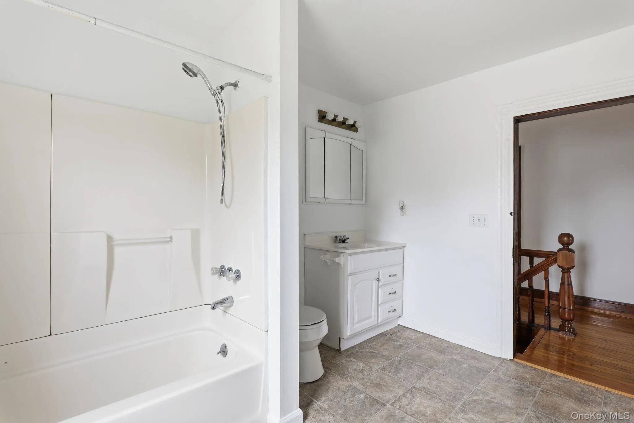 Bathroom featuring vanity and shower / bath combination Bathroom featuring vanity and shower / bath combination