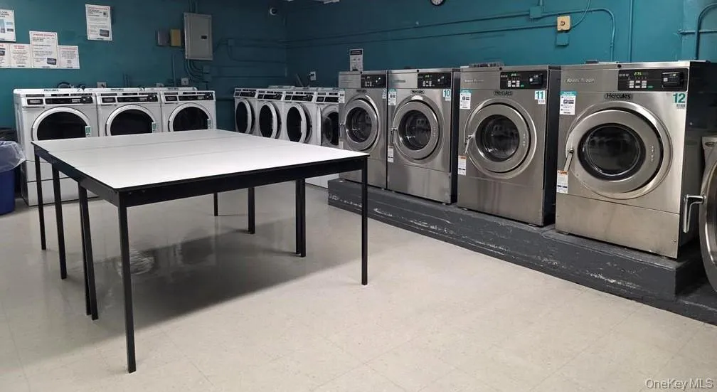 Laundry area with independent washer and dryer and electric panel Laundry area with independent washer and dryer and electric panel
