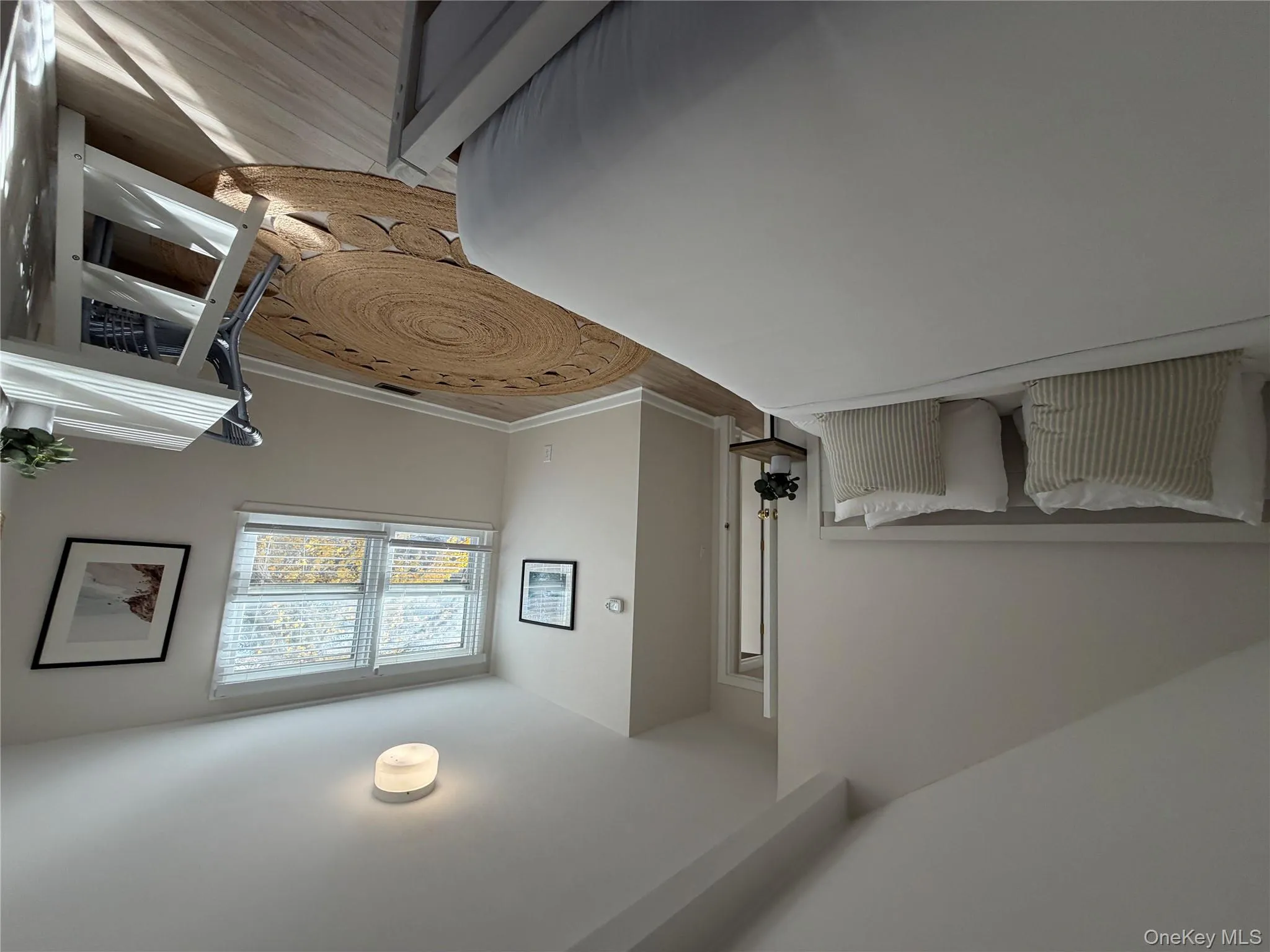 Bedroom with light wood finished floors and baseboards Bedroom with light wood finished floors and baseboards