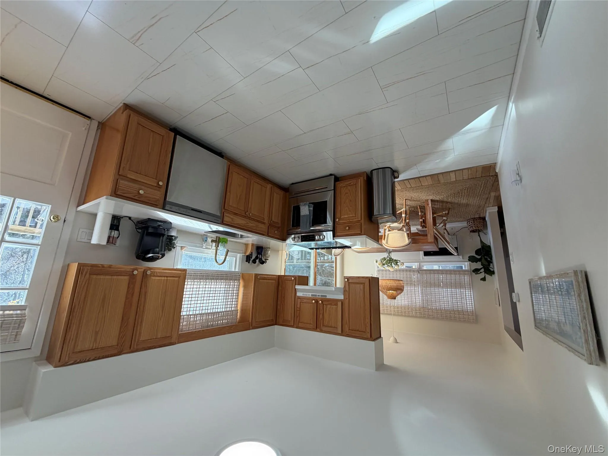 Kitchen with brown cabinets, stainless steel stove, dishwasher, and exhaust hood Kitchen with brown cabinets, stainless steel stove, dishwasher, and exhaust hood