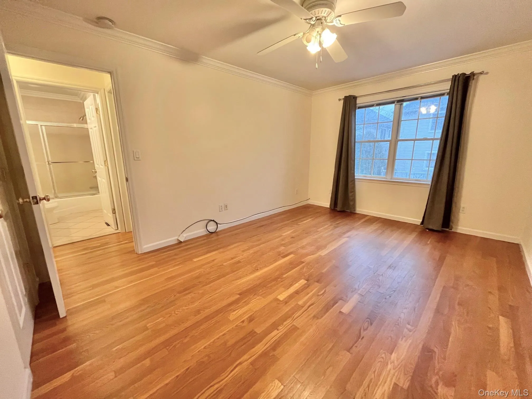 Unfurnished room with light wood-type flooring, crown molding, and a ceiling fan Unfurnished room with light wood-type flooring, crown molding, and a ceiling fan