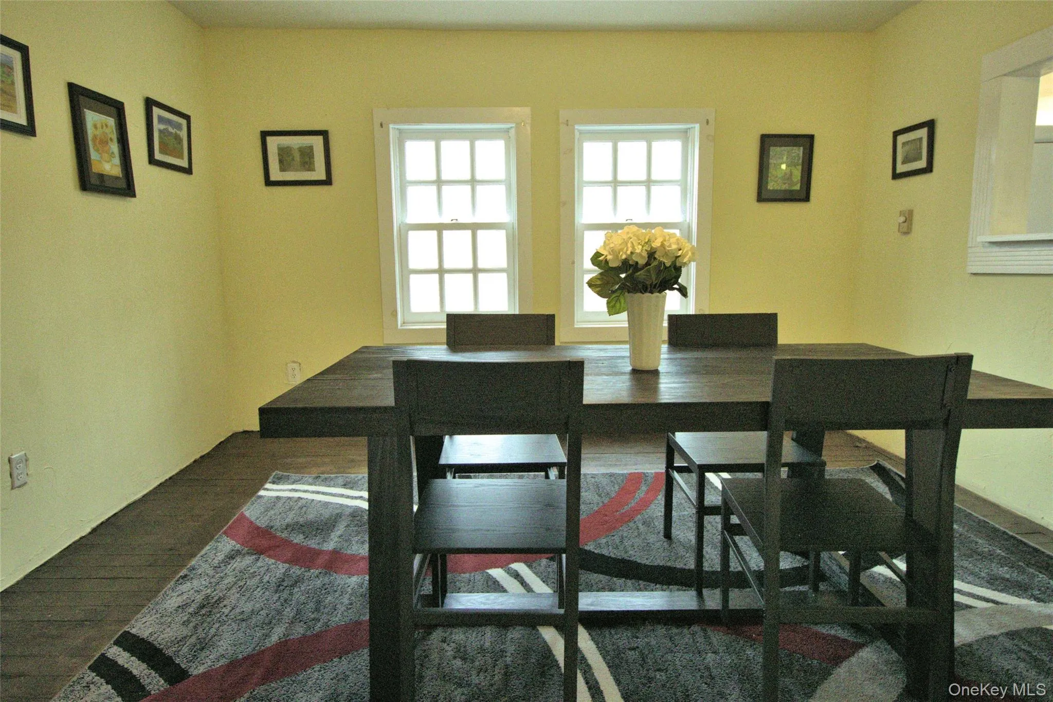 Dining area featuring dark wood-style flooring Dining area featuring dark wood-style flooring