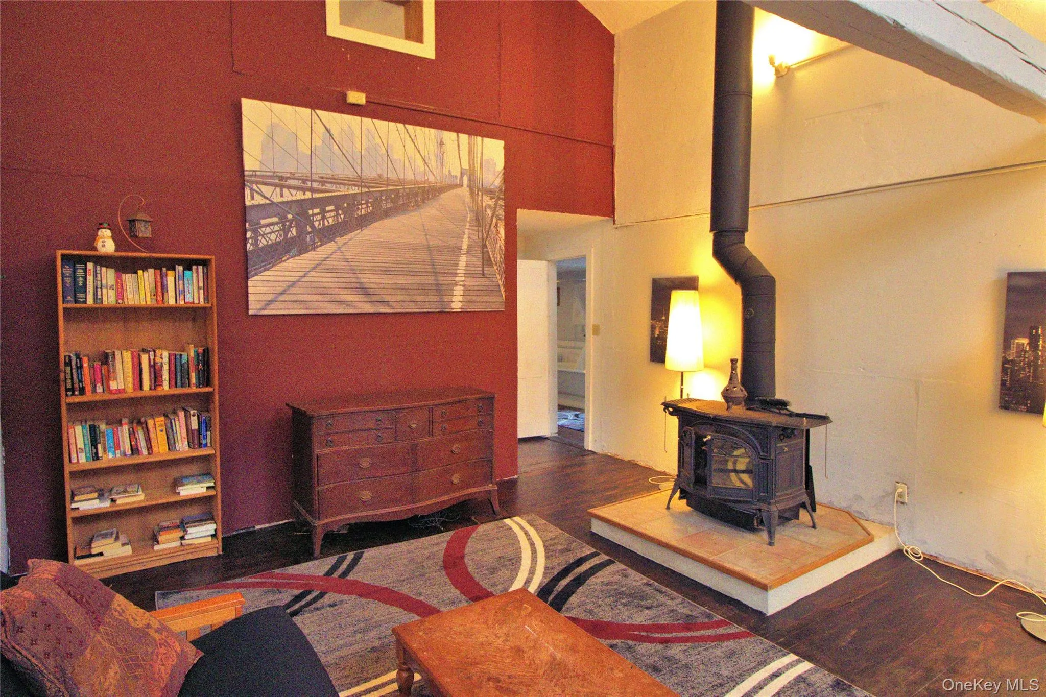 Living room with a wood stove and dark wood-style flooring Living room with a wood stove and dark wood-style flooring
