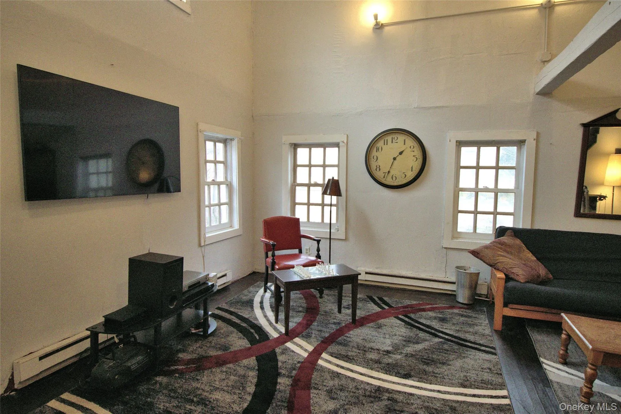 Living area with healthy amount of natural light, a baseboard heating unit, and baseboard heating Living area with healthy amount of natural light, a baseboard heating unit, and baseboard heating