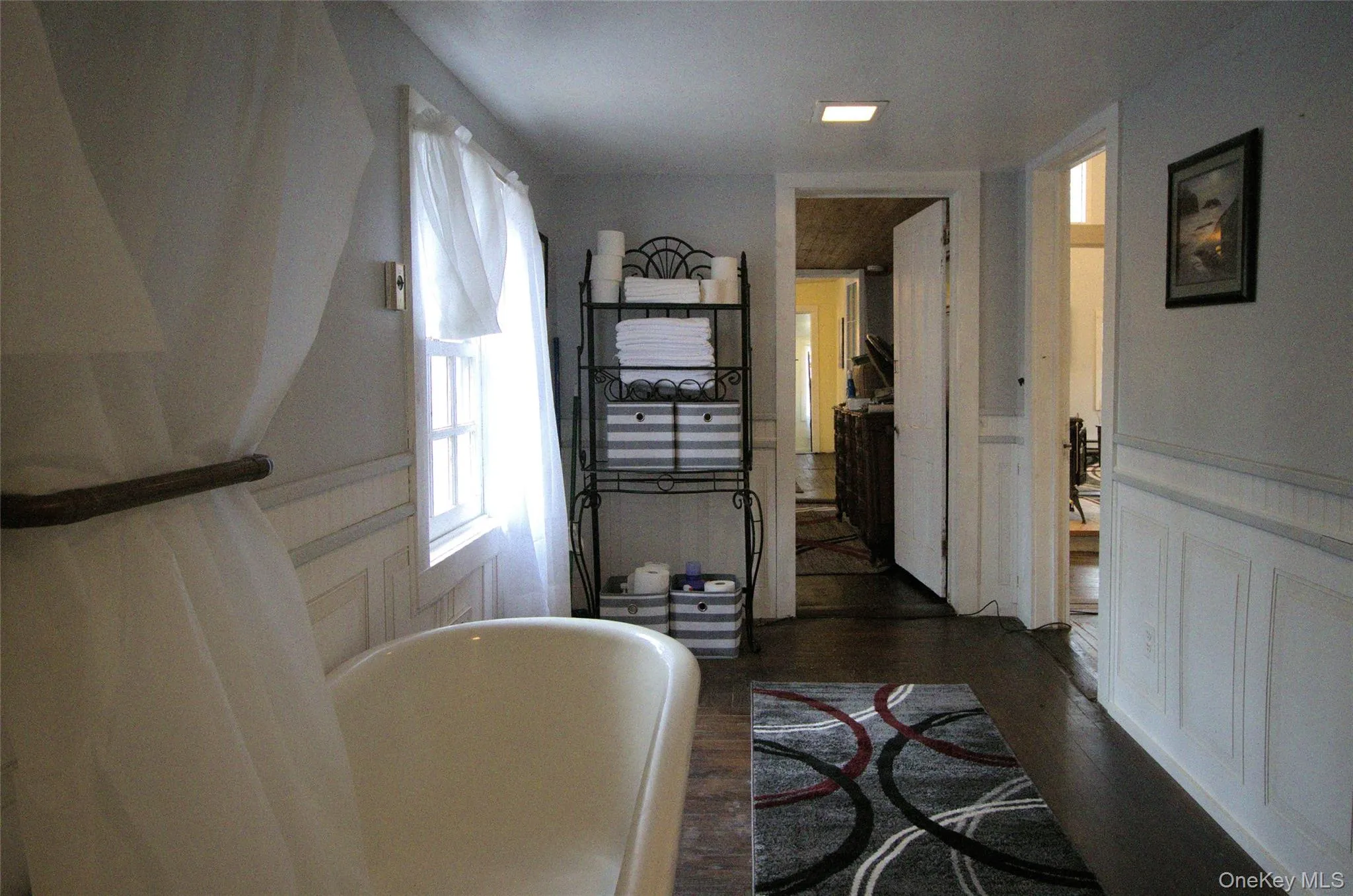 Hallway featuring dark wood-type flooring Hallway featuring dark wood-type flooring