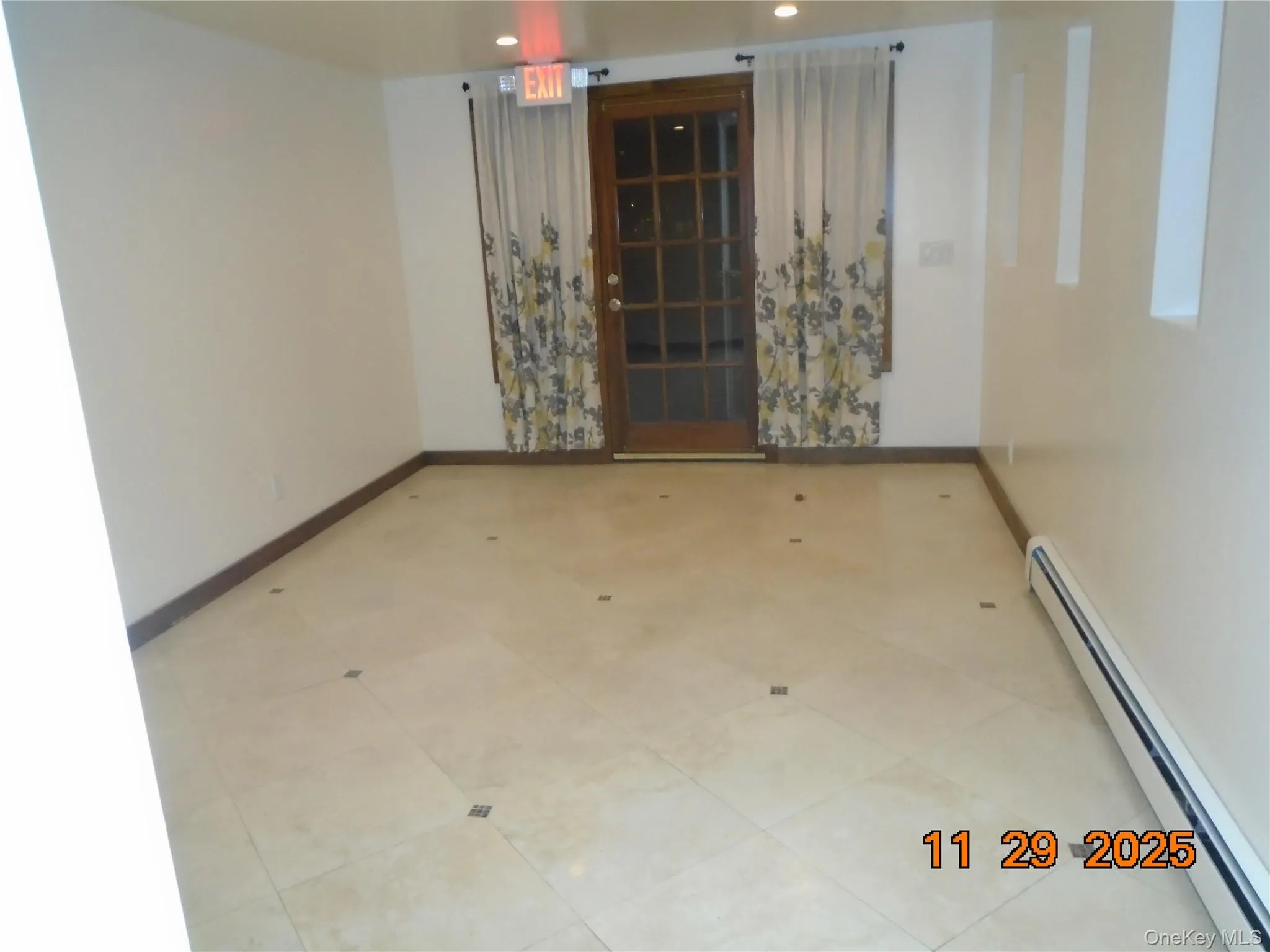 Unfurnished room with a baseboard radiator, recessed lighting, and tile patterned flooring Unfurnished room with a baseboard radiator, recessed lighting, and tile patterned flooring