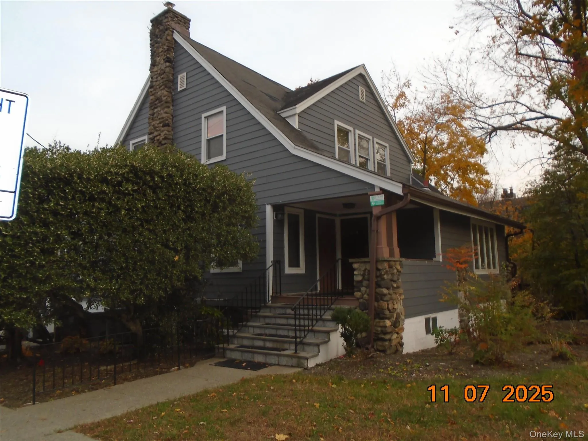 View of front of property featuring a porch and a chimney View of front of property featuring a porch and a chimney
