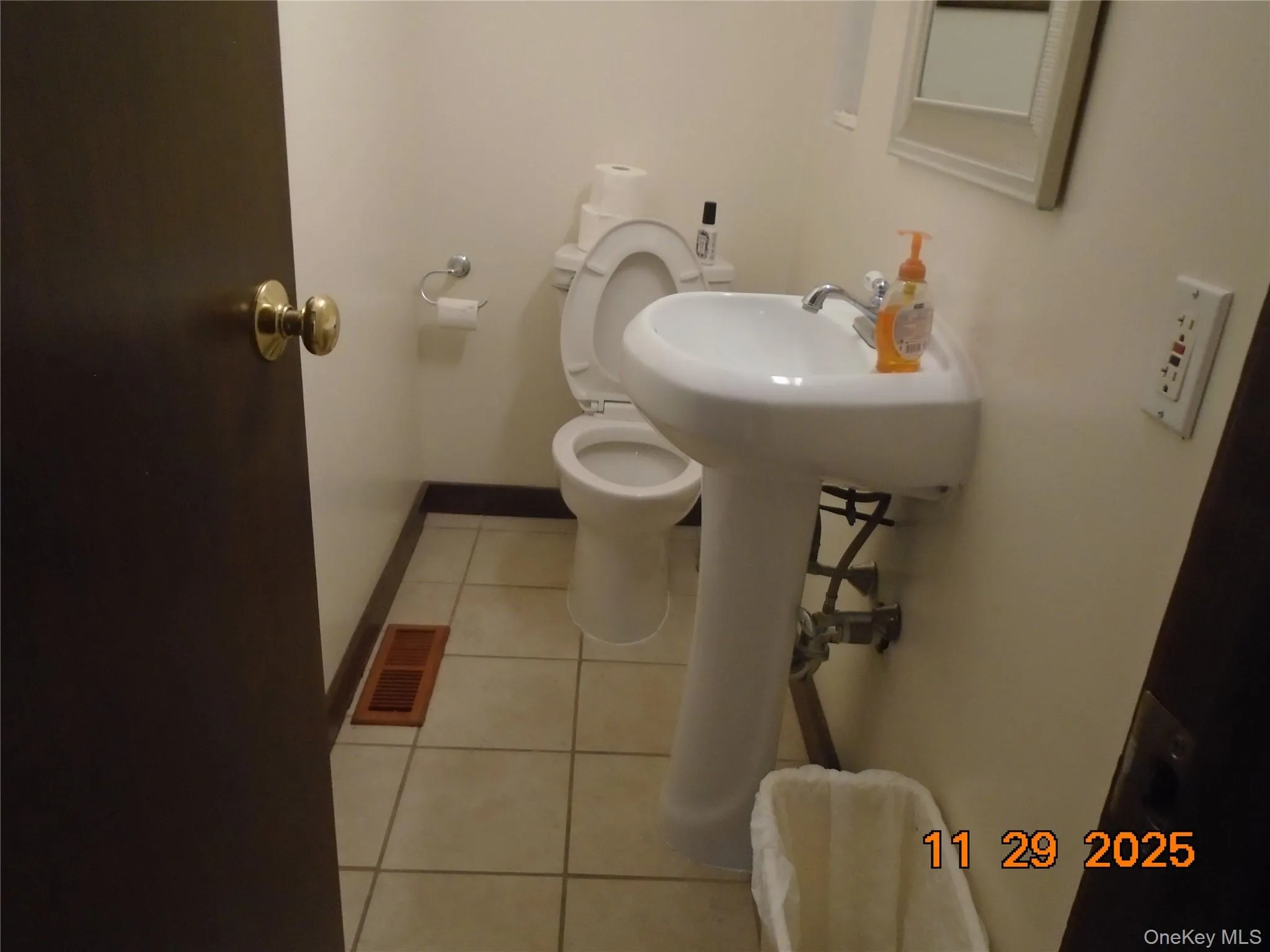 Bathroom with light tile patterned floors and baseboards Bathroom with light tile patterned floors and baseboards