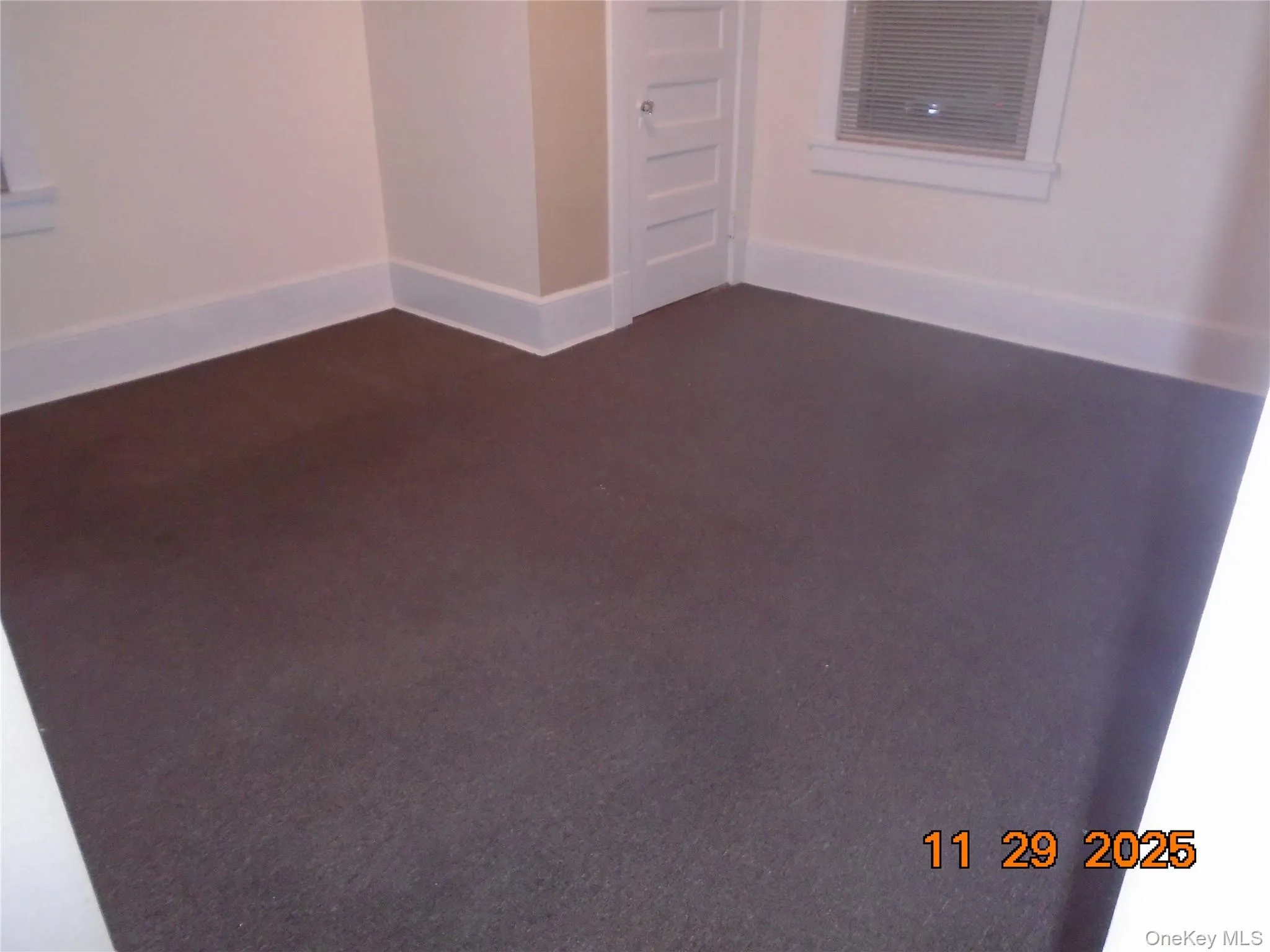 Unfurnished room with dark carpet Unfurnished room with dark carpet