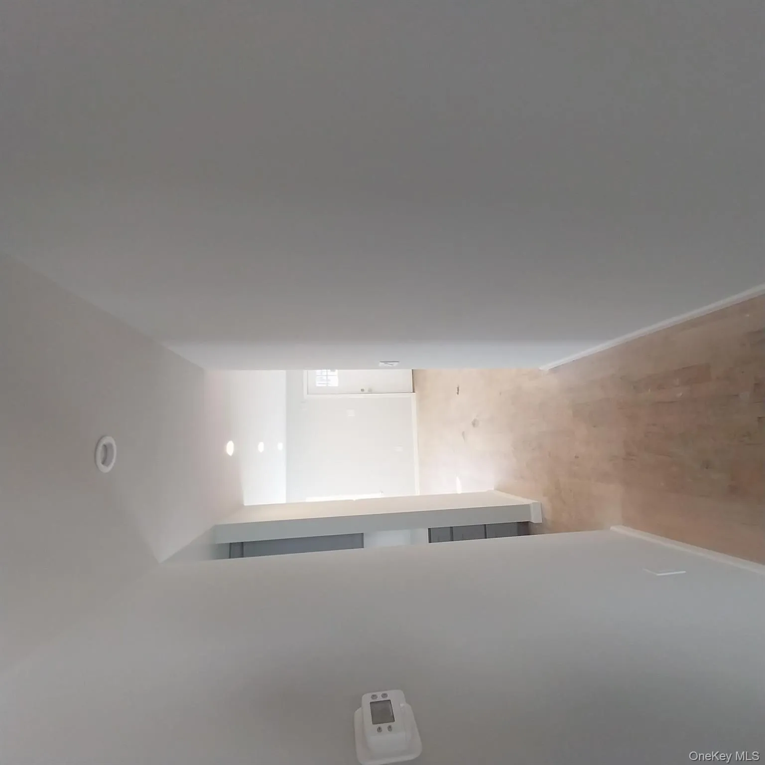 Hall with recessed lighting and light wood-style floors Hall with recessed lighting and light wood-style floors