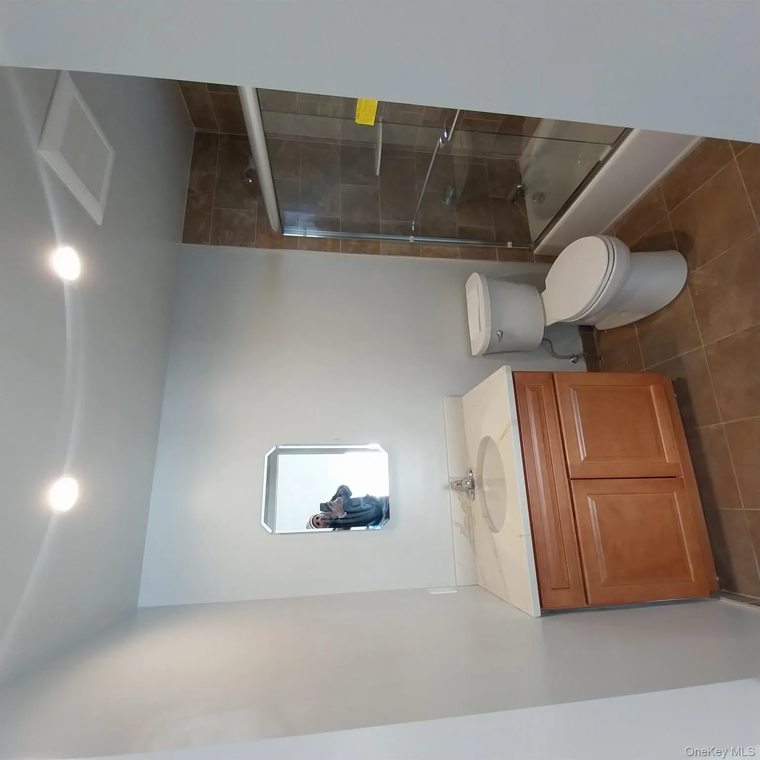 Full bathroom with vanity, dark tile patterned flooring, enclosed tub / shower combo, and recessed lighting Full bathroom with vanity, dark tile patterned flooring, enclosed tub / shower combo, and recessed lighting