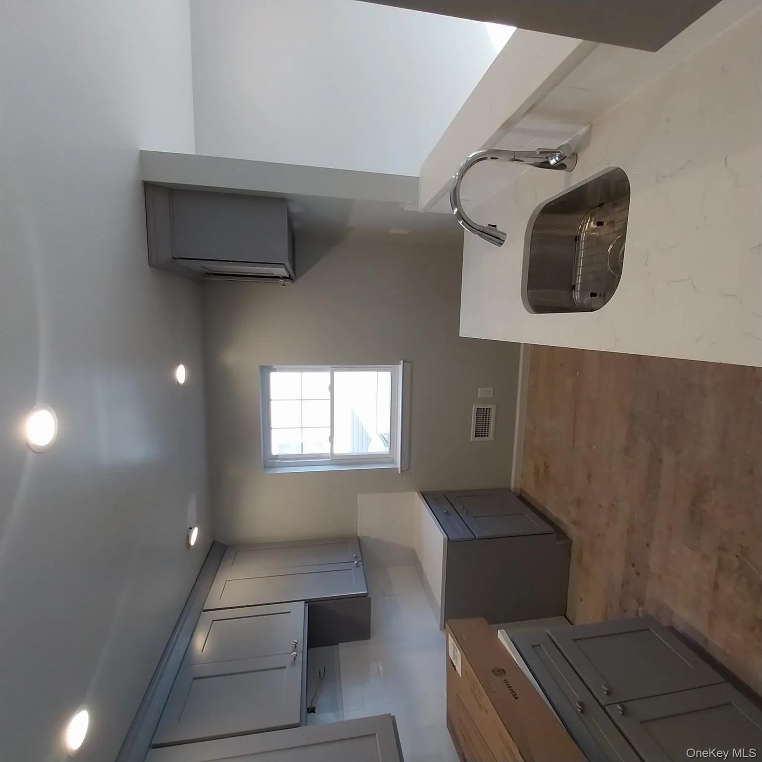 Laundry area featuring a sink and recessed lighting Laundry area featuring a sink and recessed lighting