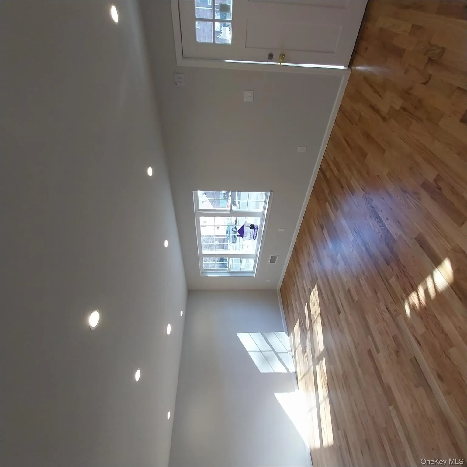 Unfurnished living room featuring light wood-type flooring and recessed lighting Unfurnished living room featuring light wood-type flooring and recessed lighting