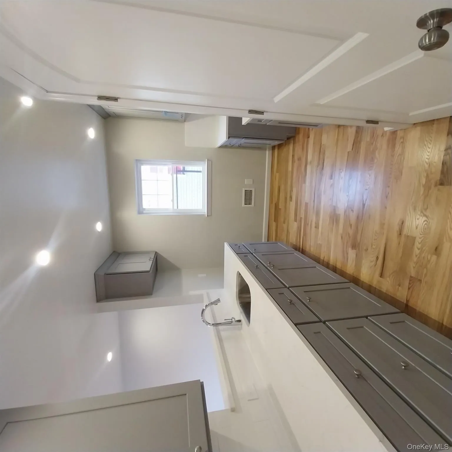 Laundry room with light wood finished floors and recessed lighting Laundry room with light wood finished floors and recessed lighting