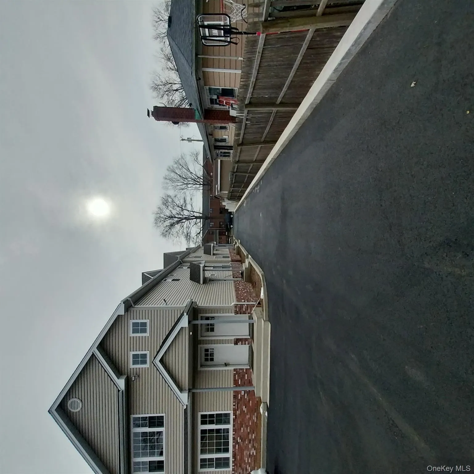 View of asphalt road with a residential view View of asphalt road with a residential view