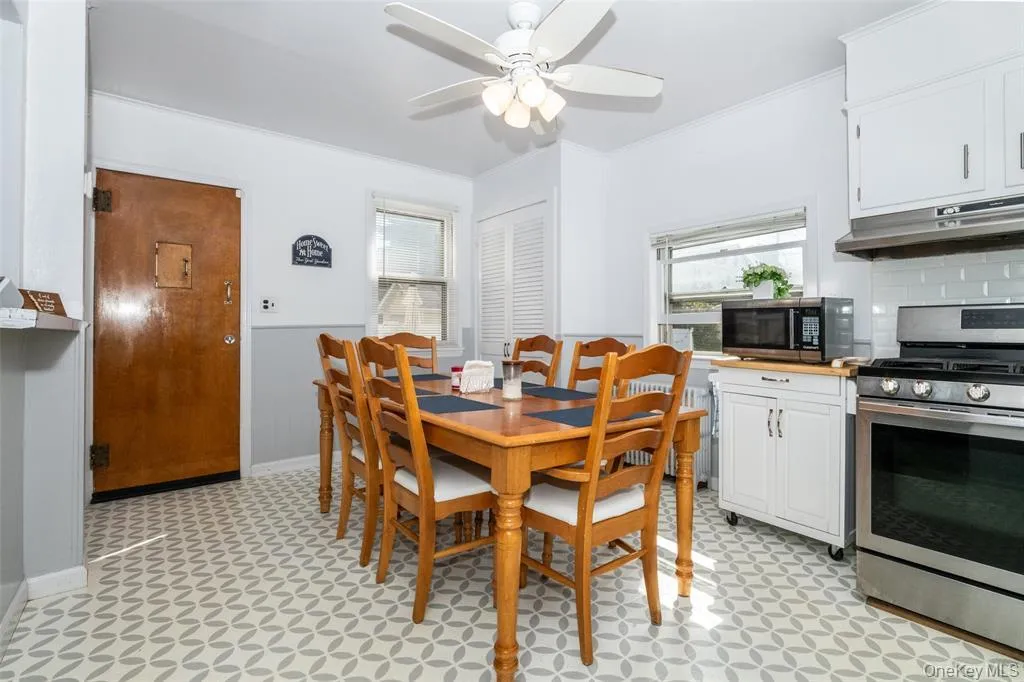 Dining area featuring light flooring and crown molding Dining area featuring light flooring and crown molding