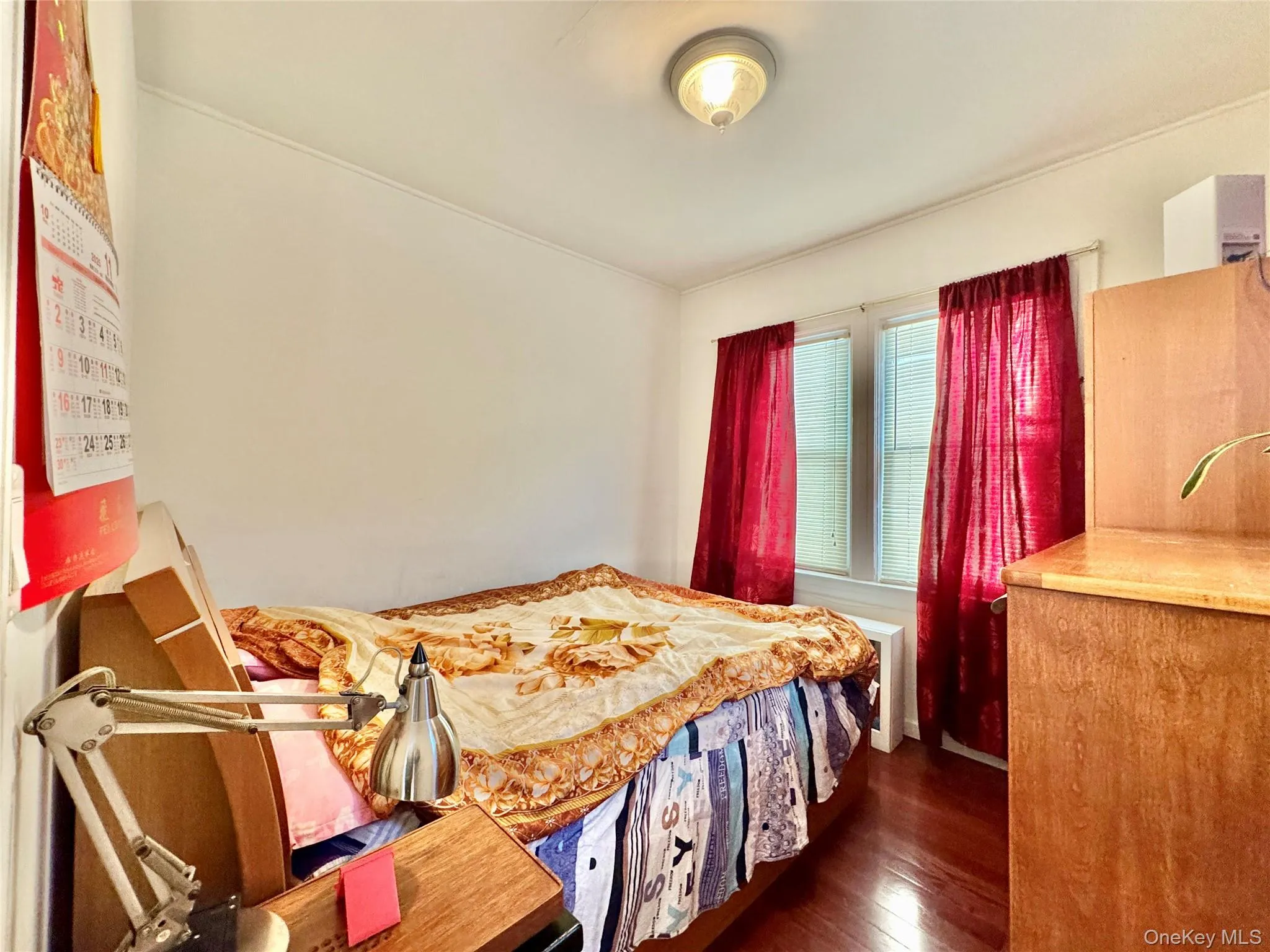 Bedroom featuring dark wood finished floors Bedroom featuring dark wood finished floors