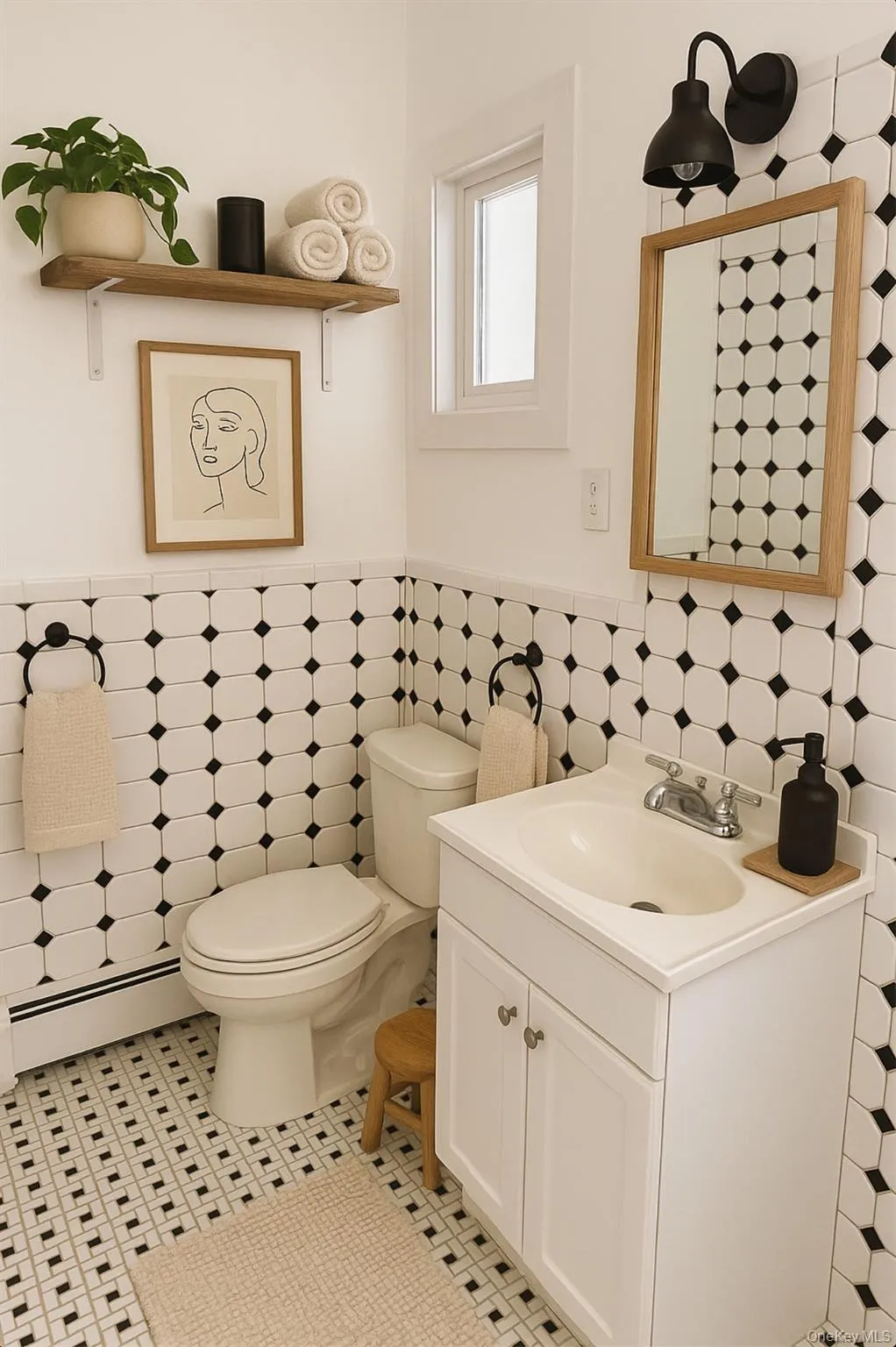 Bathroom featuring vanity, a baseboard radiator, tile walls, wainscoting, and light tile patterned floors Bathroom featuring vanity, a baseboard radiator, tile walls, wainscoting, and light tile patterned floors