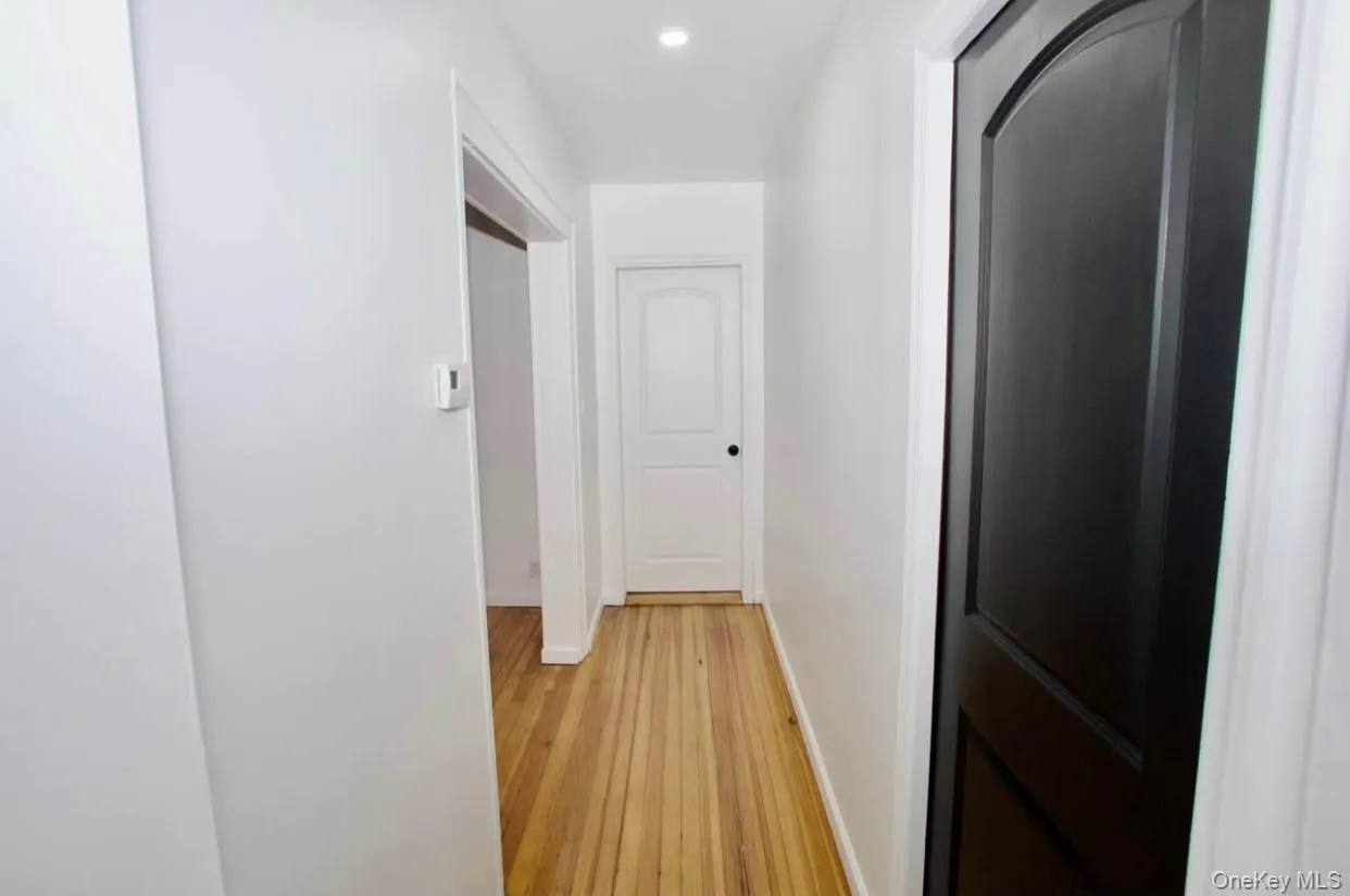 Corridor featuring light wood-style floors and recessed lighting Corridor featuring light wood-style floors and recessed lighting