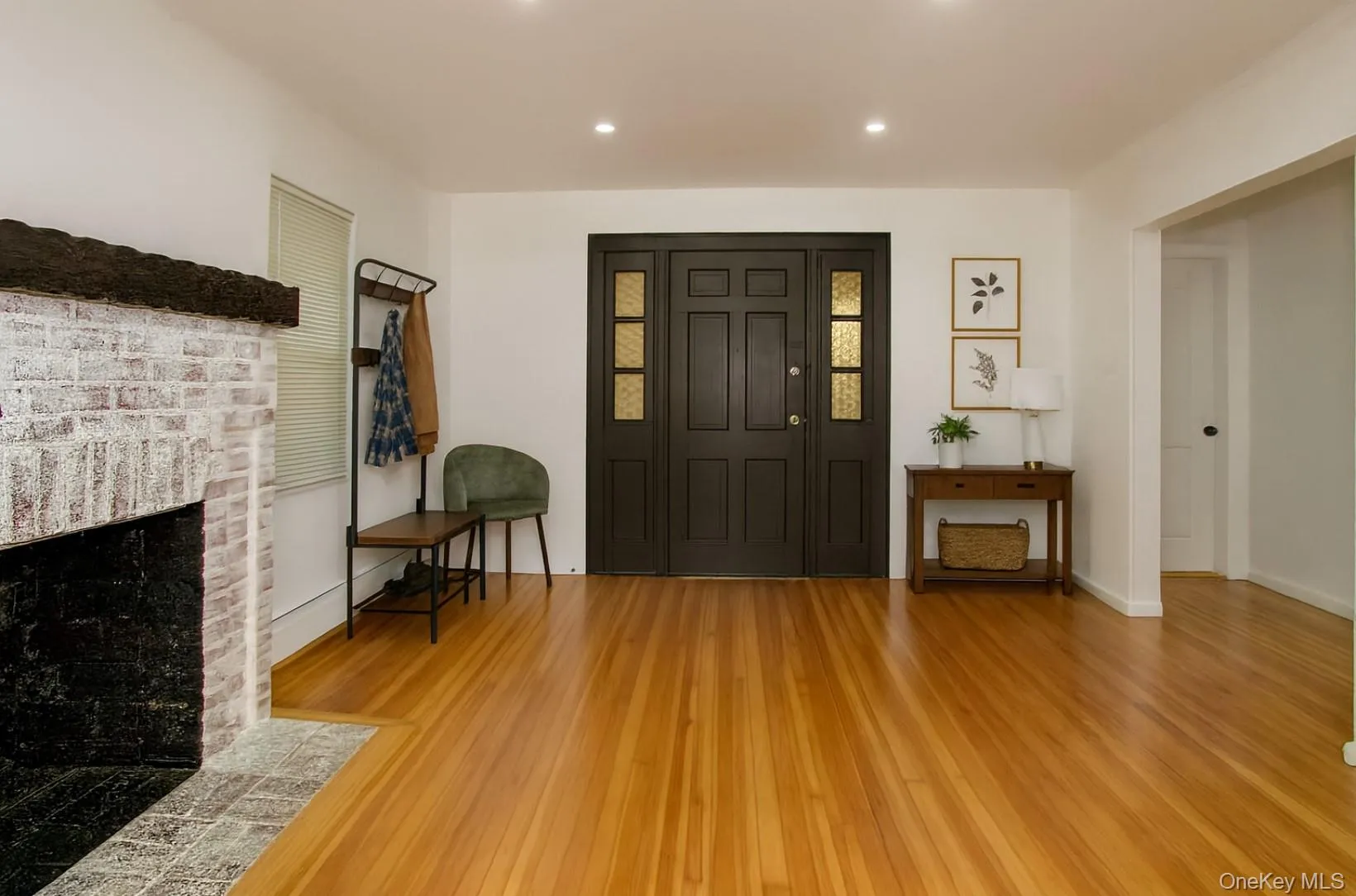 Entryway with light wood-type flooring, a brick fireplace, and recessed lighting Entryway with light wood-type flooring, a brick fireplace, and recessed lighting