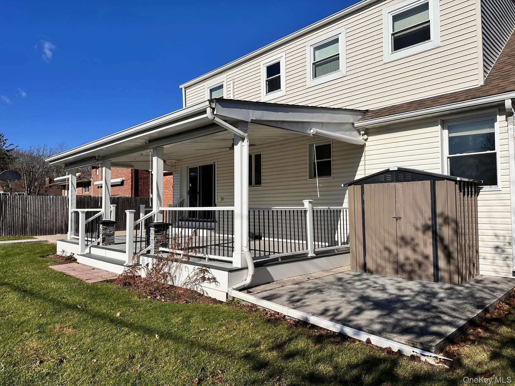 Rear view of house featuring a storage unit and a porch Rear view of house featuring a storage unit and a porch