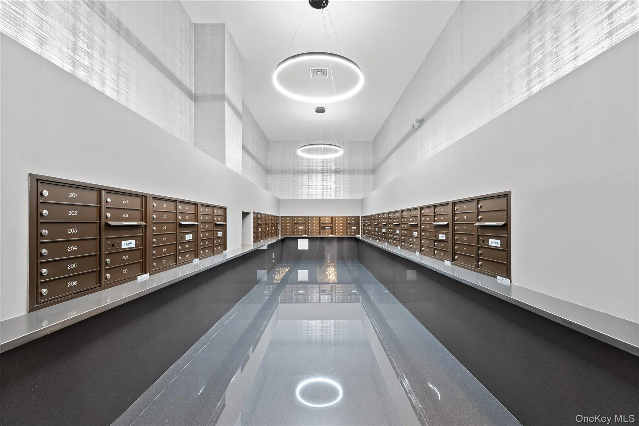 Surrounding community with a towering ceiling and mail area Surrounding community with a towering ceiling and mail area