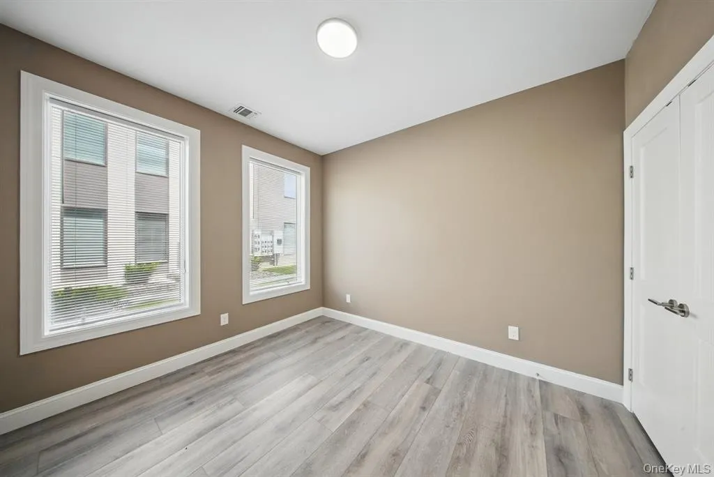 Empty room with baseboards and light wood finished floors Empty room with baseboards and light wood finished floors