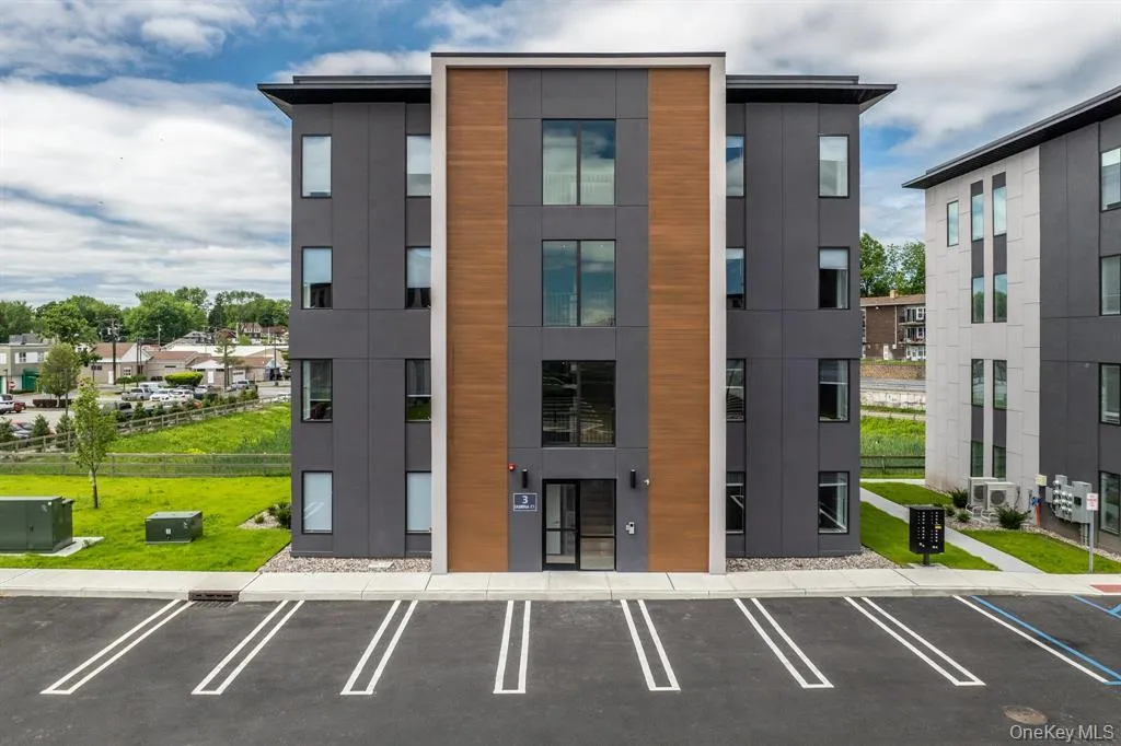 View of apartment building / complex featuring uncovered parking View of apartment building / complex featuring uncovered parking