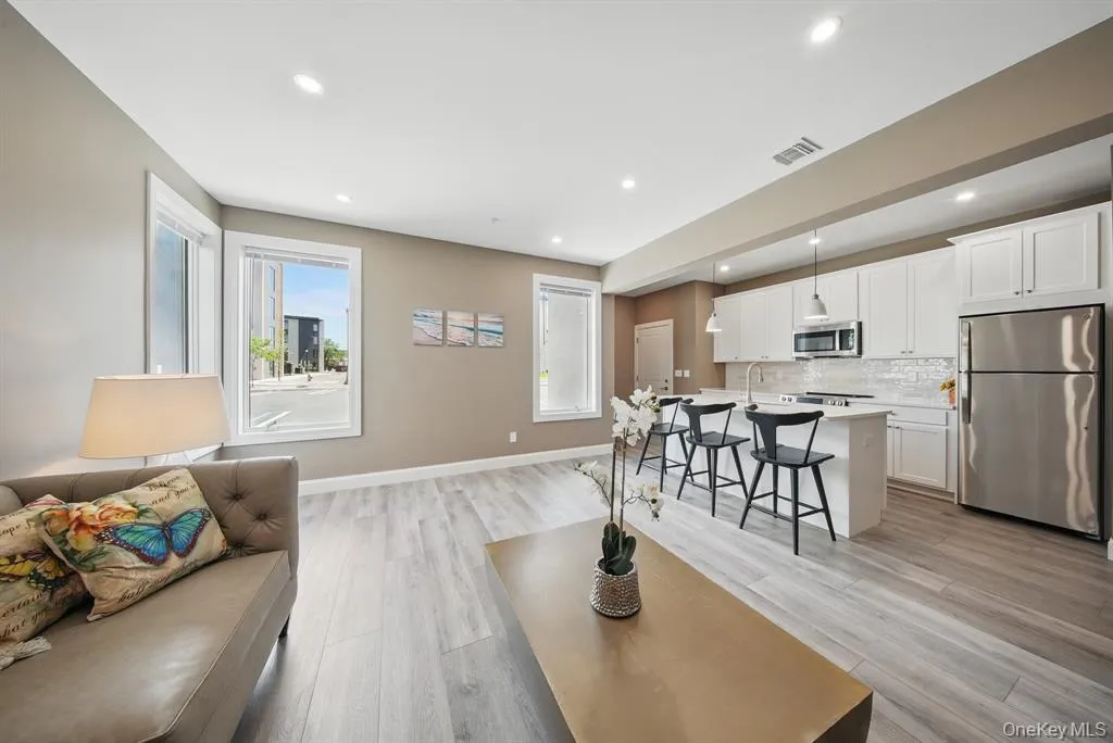 Living area featuring light wood finished floors and recessed lighting Living area featuring light wood finished floors and recessed lighting