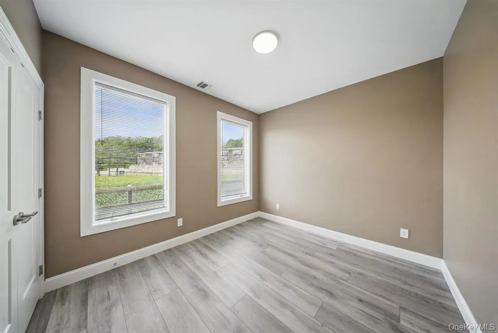 Unfurnished room featuring baseboards and light wood-style flooring Unfurnished room featuring baseboards and light wood-style flooring