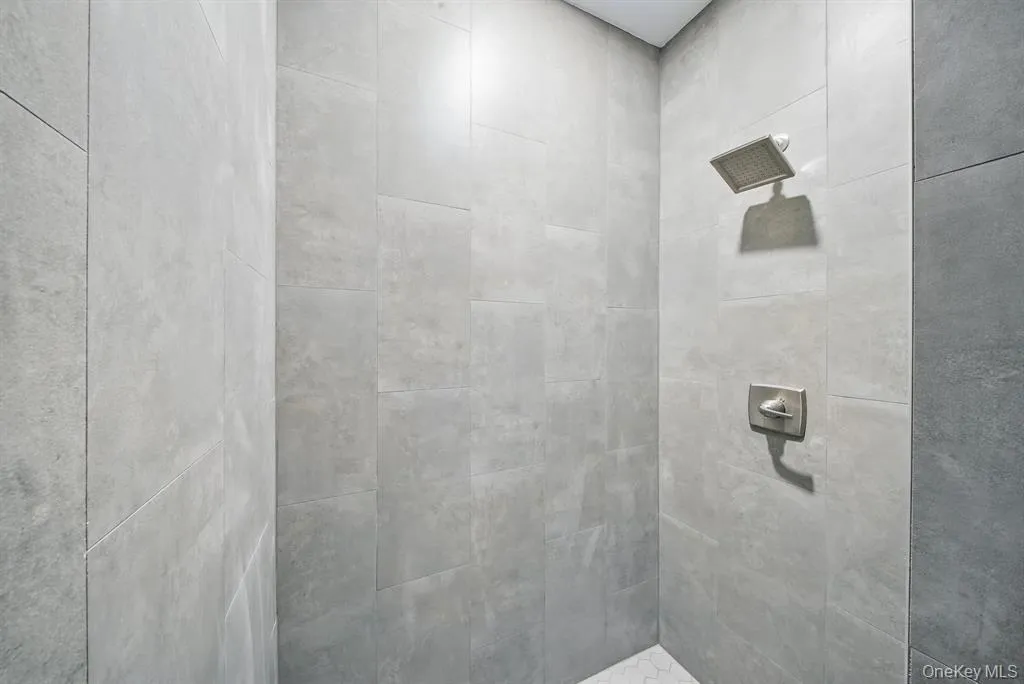 Bathroom featuring tiled shower Bathroom featuring tiled shower