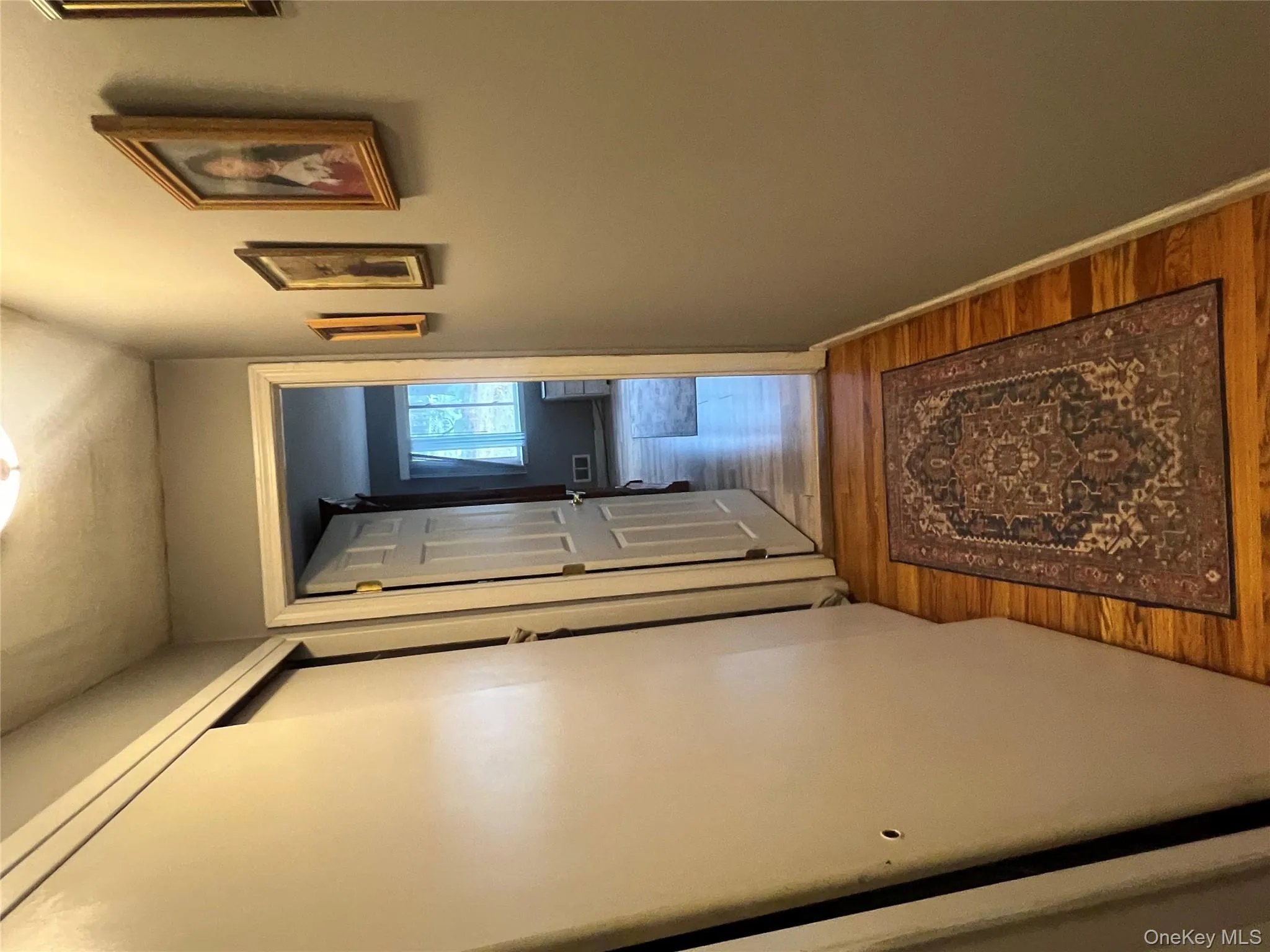 Corridor featuring wood finished floors and baseboards Corridor featuring wood finished floors and baseboards